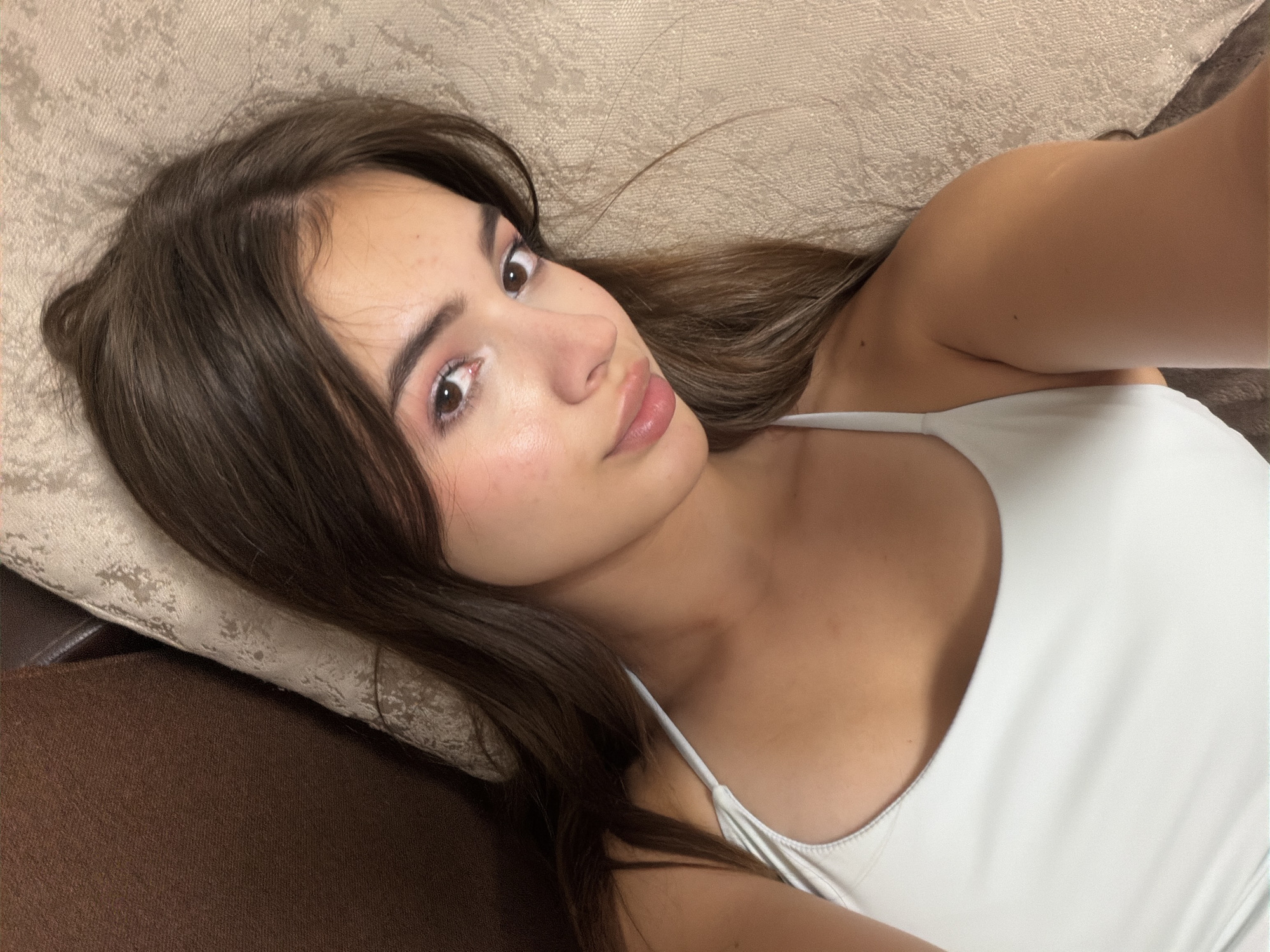Overhead close-up of someone resting on a couch indoors