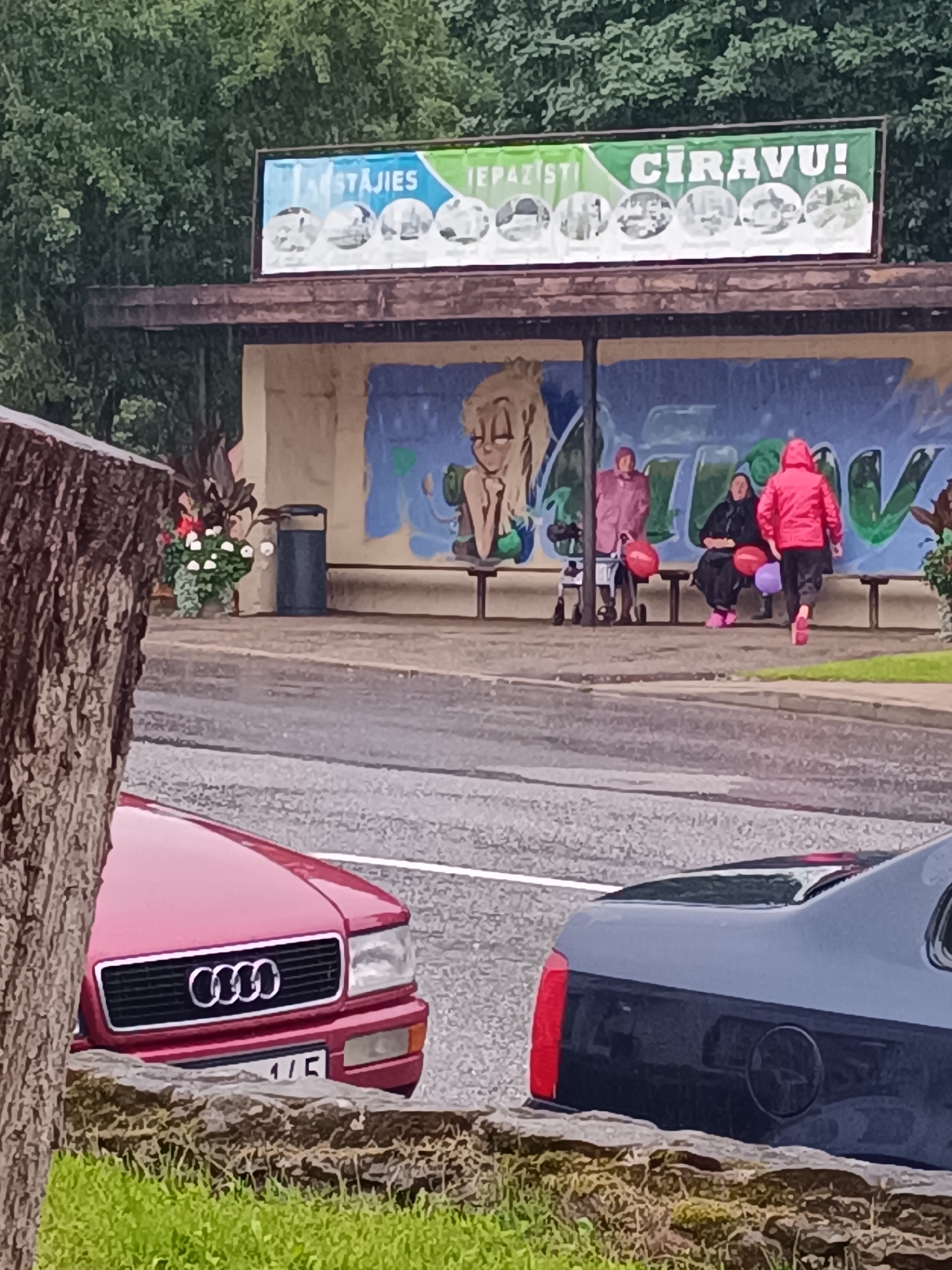 Vintage vehicle parade rolls through rainy Cīrava, Latvia
