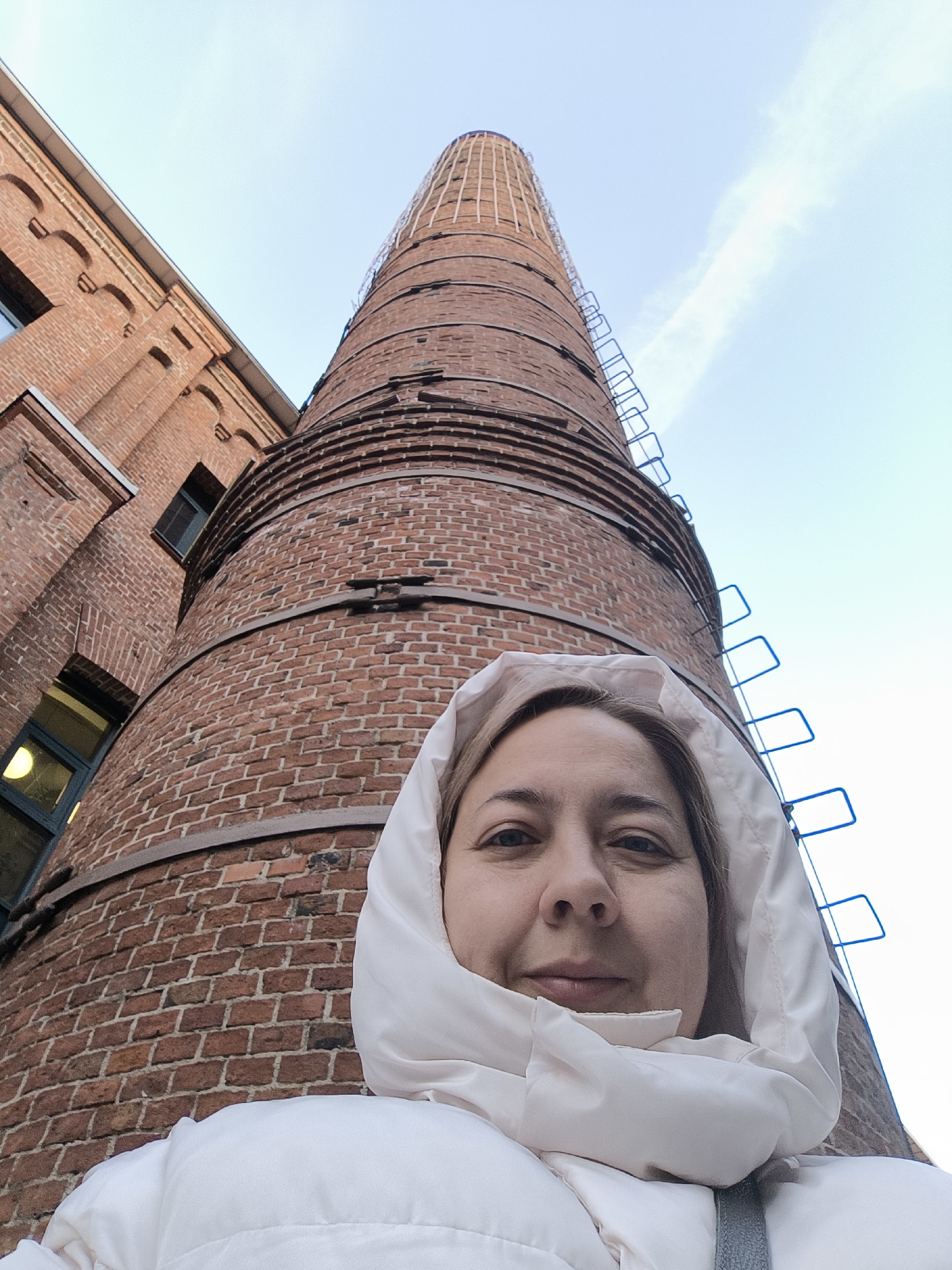 Woman photographs herself near Moscow's red brick industrial district