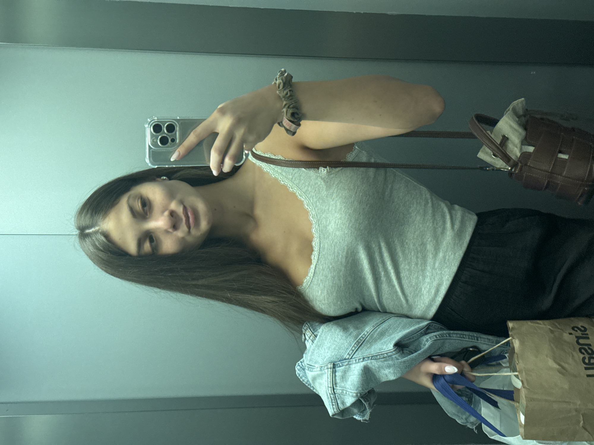 Woman takes mirror selfie in Burgas interior space