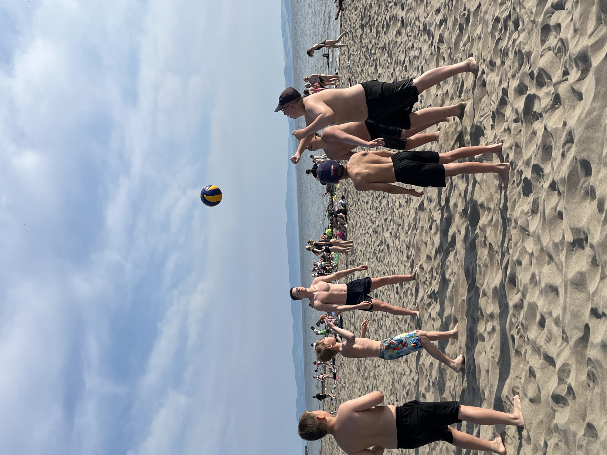 Beach day on a Russian lake — volleyball, sun, and mountain views