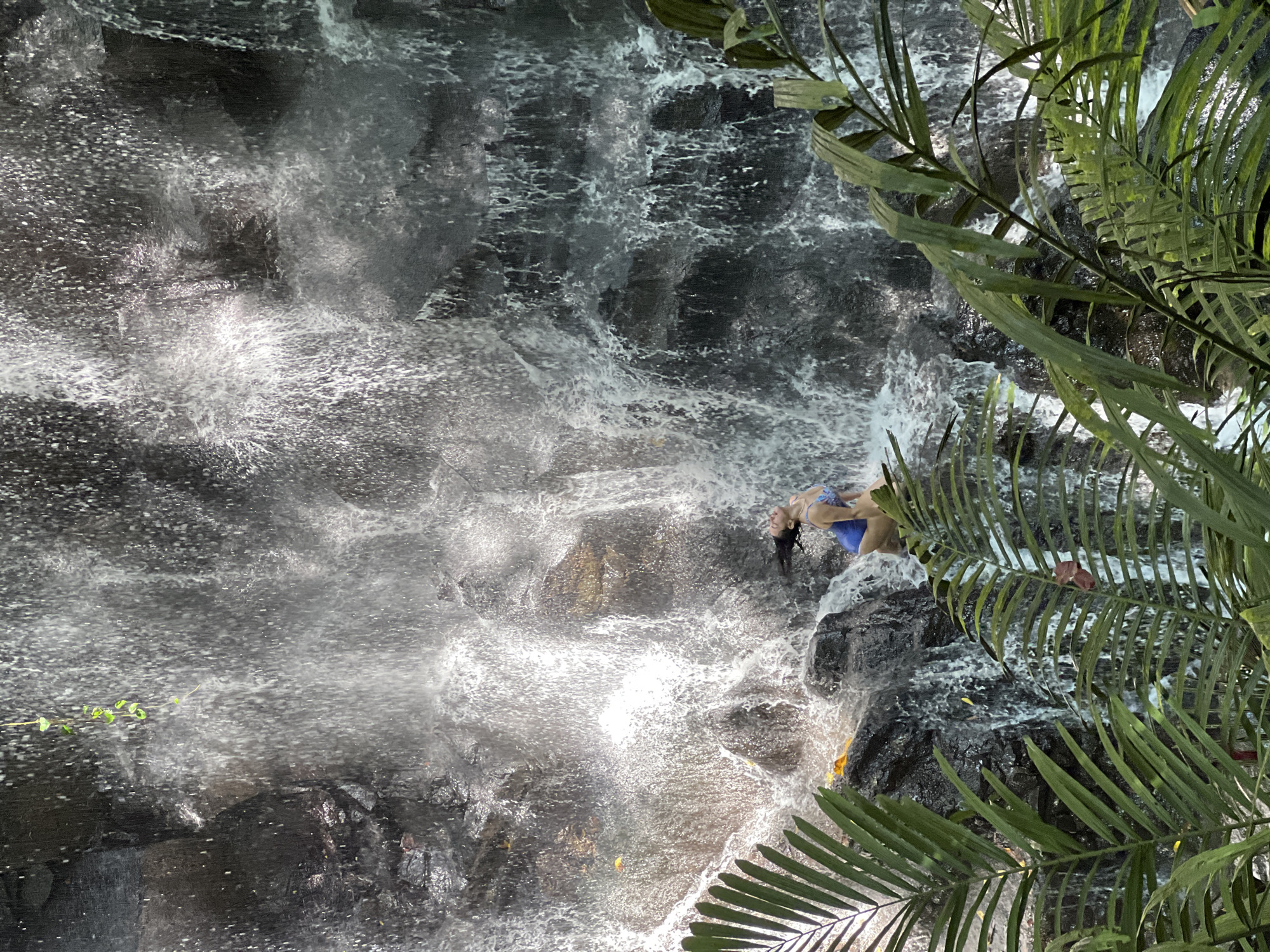 Tourists enjoy early morning waterfall activities in Gianyar, Indonesia