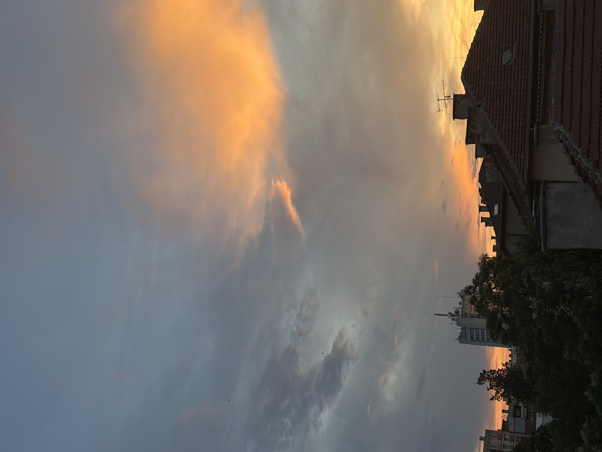 Dramatic sunset illuminates city skyline with vibrant colors