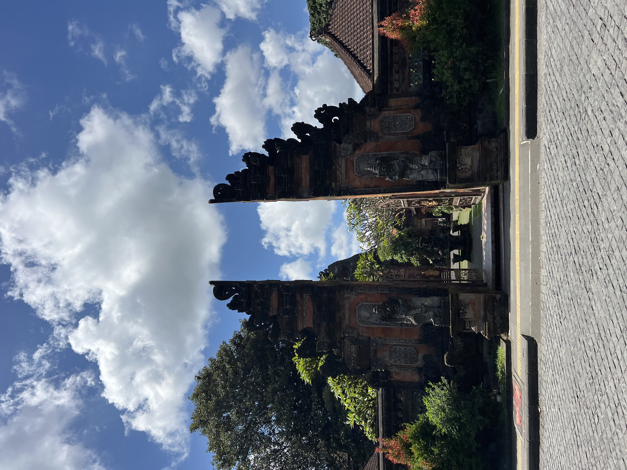 Traditional Balinese gate captured in Ubud under cloudy skies
