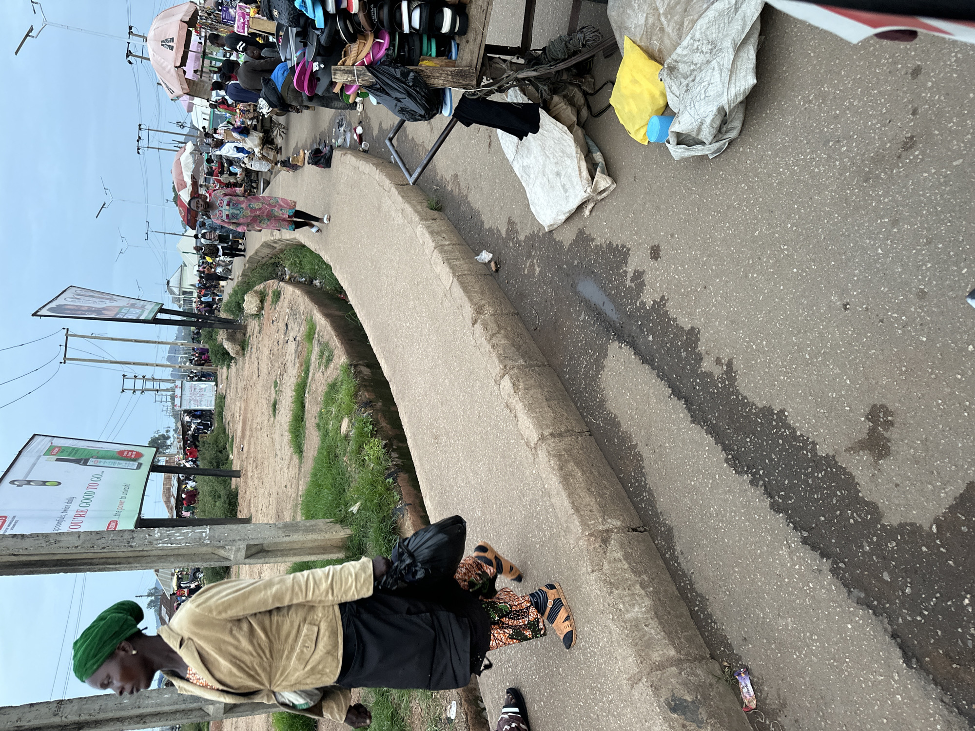 Bukuru market district at dusk, vendors and street traffic