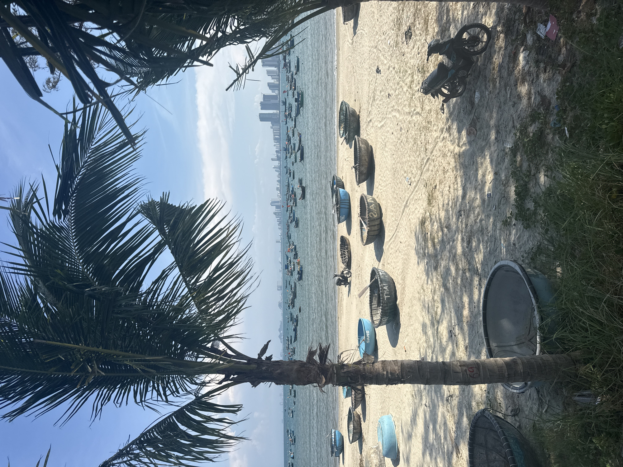 Vietnamese beach scene with traditional coracle boats documented