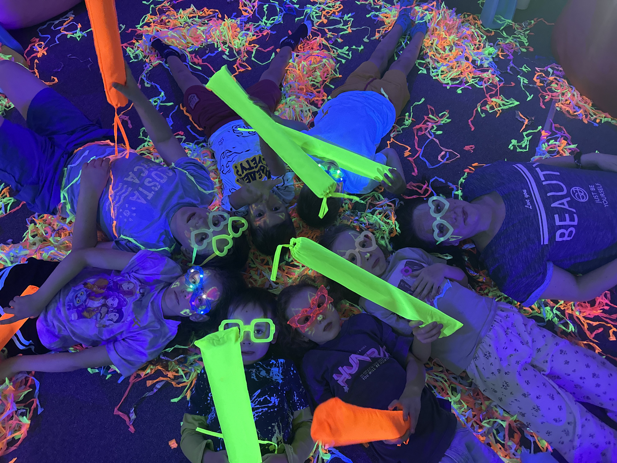 Children's blacklight party features UV face paint and confetti
