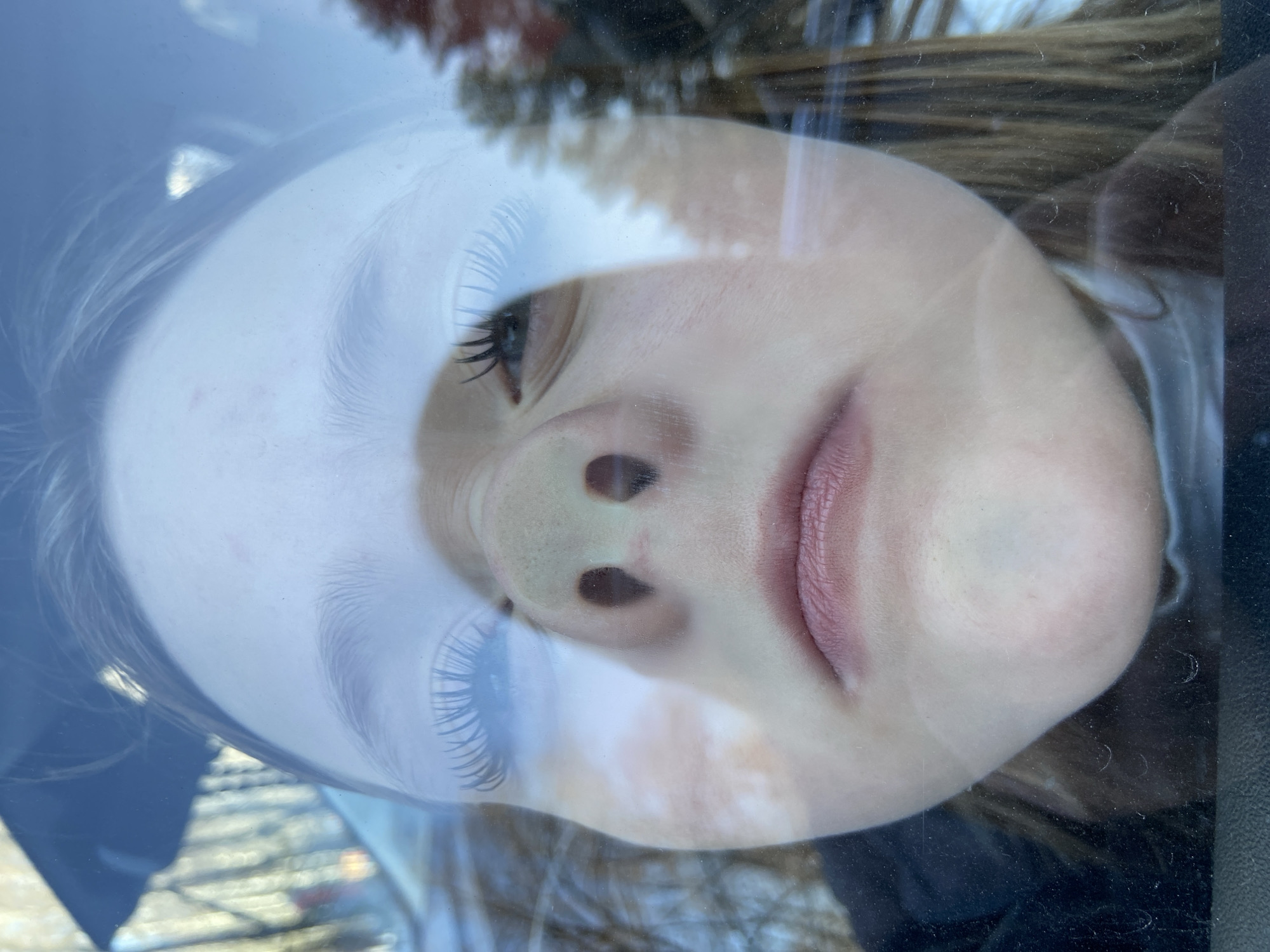 Young person photographed in car reflections in Chaikovsky