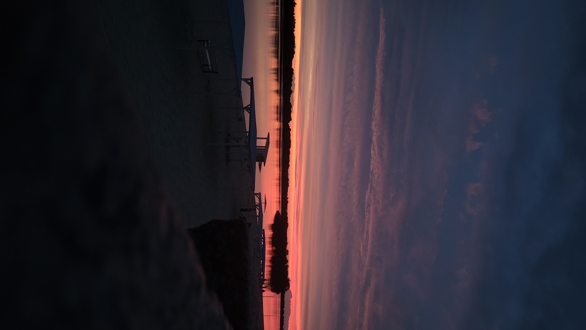 Sitting quietly by the water at sunset