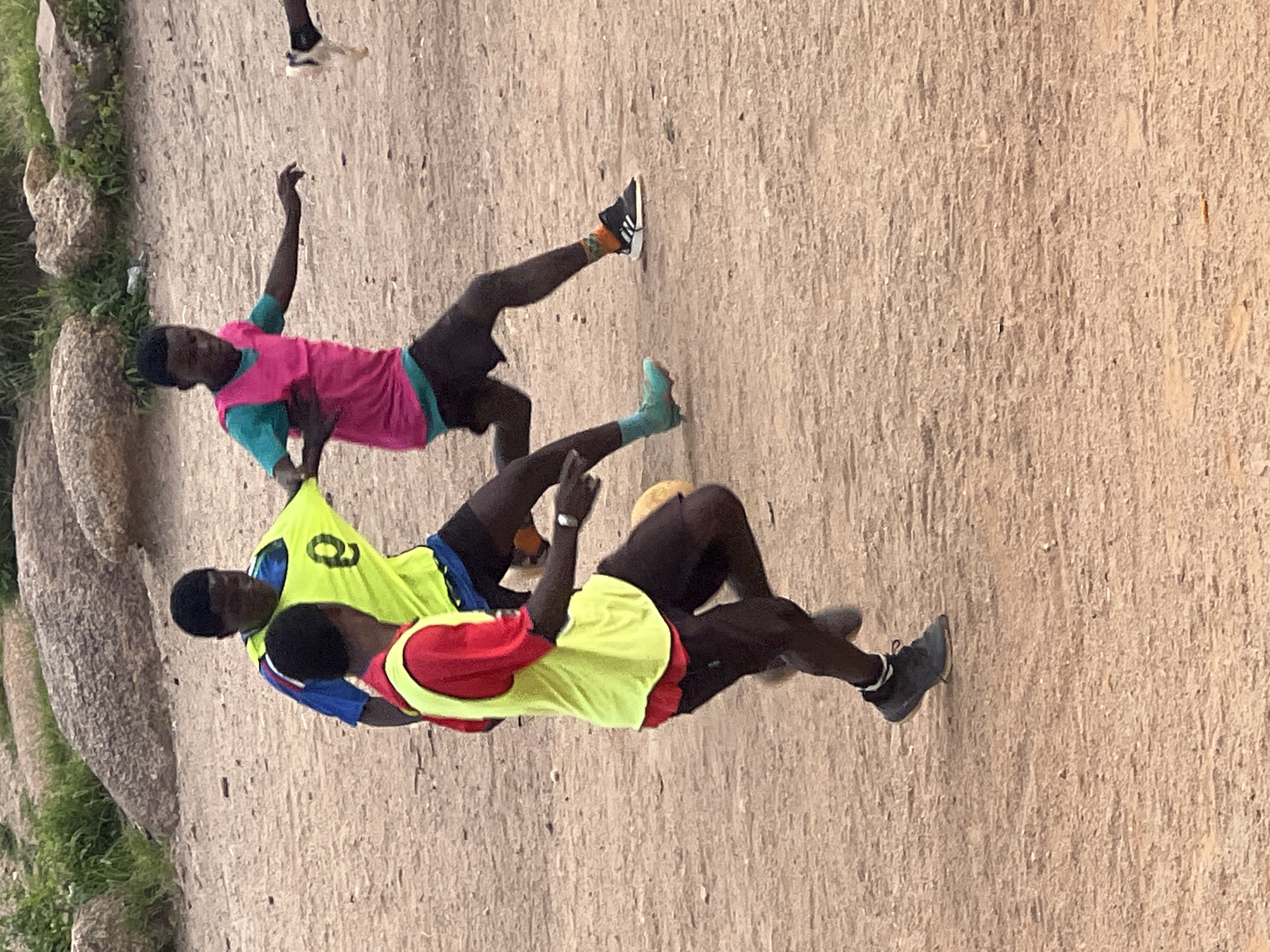Pick-up football on a rocky dirt pitch in Jos, Nigeria