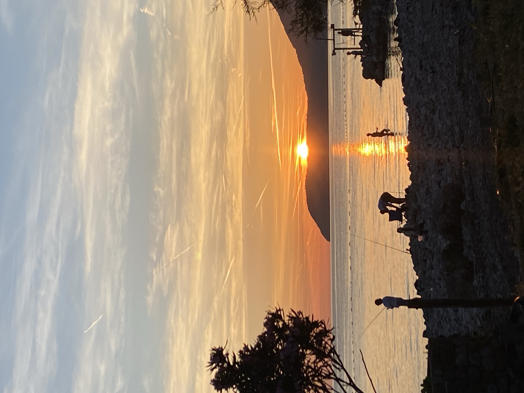 Sunset fishing and coastal leisure captured in Bar, Montenegro