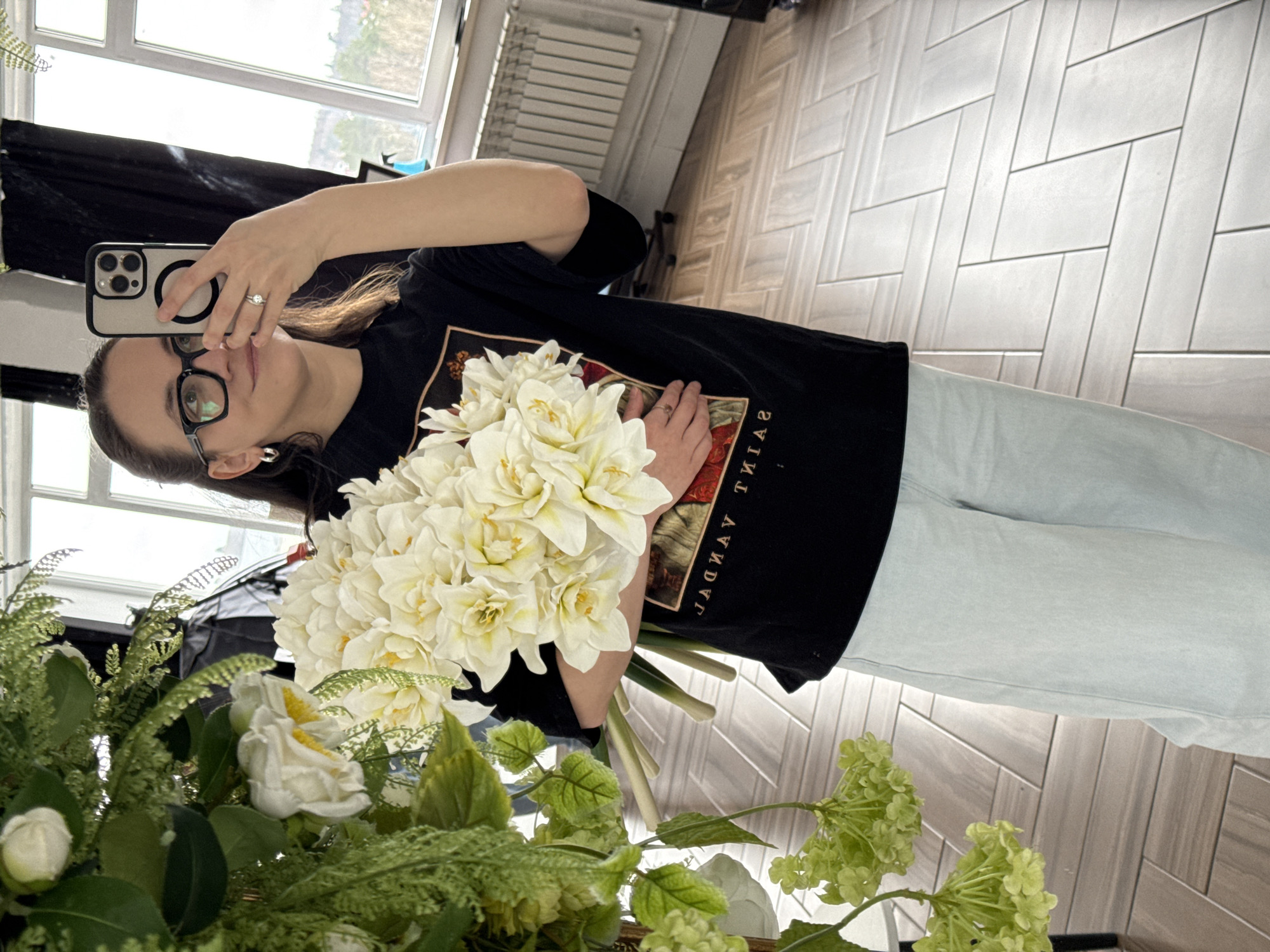 Woman poses with white flower bouquet in Chaikovsky mirror selfie