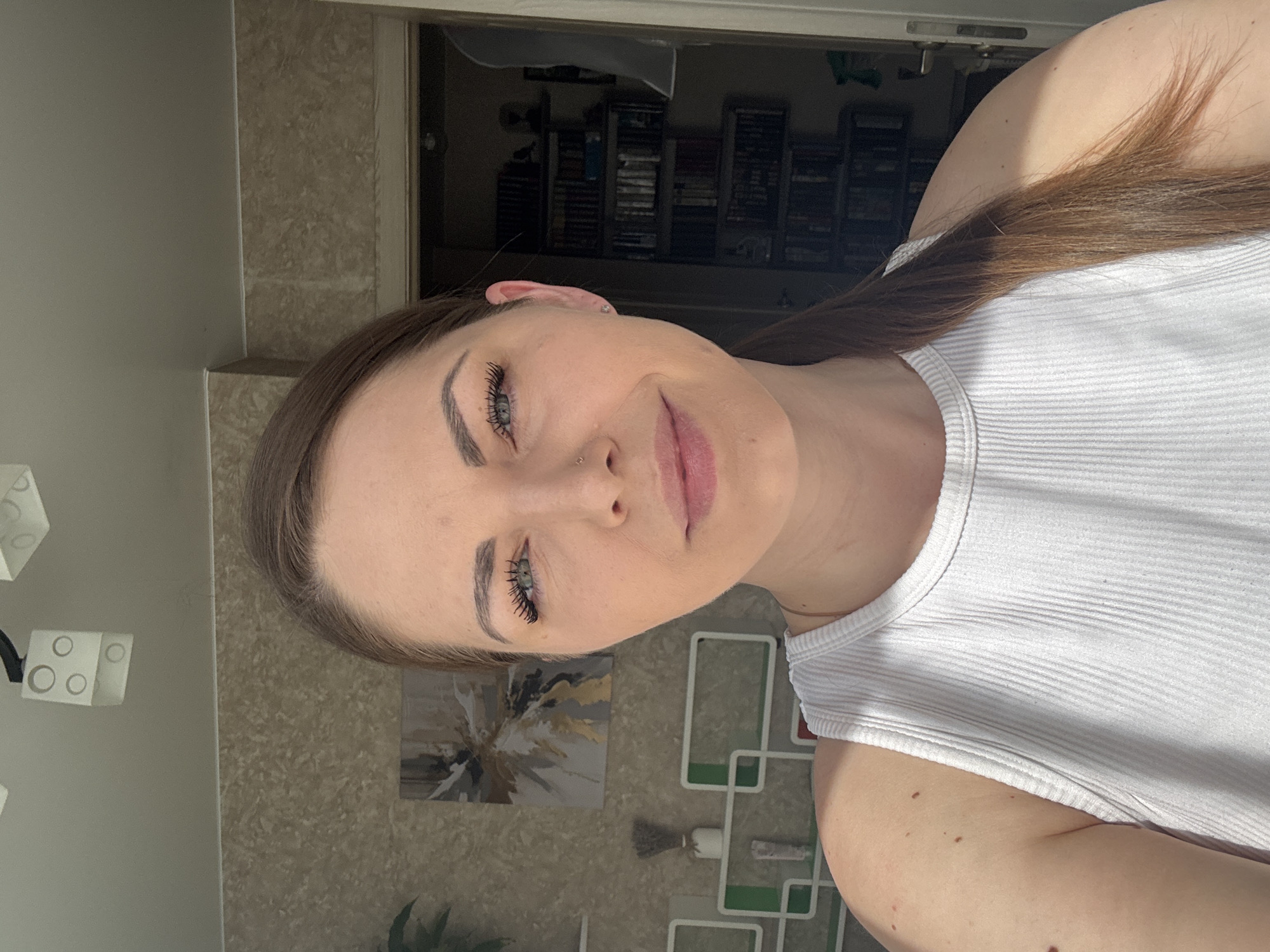 Woman in white tank top captured in close-up portrait