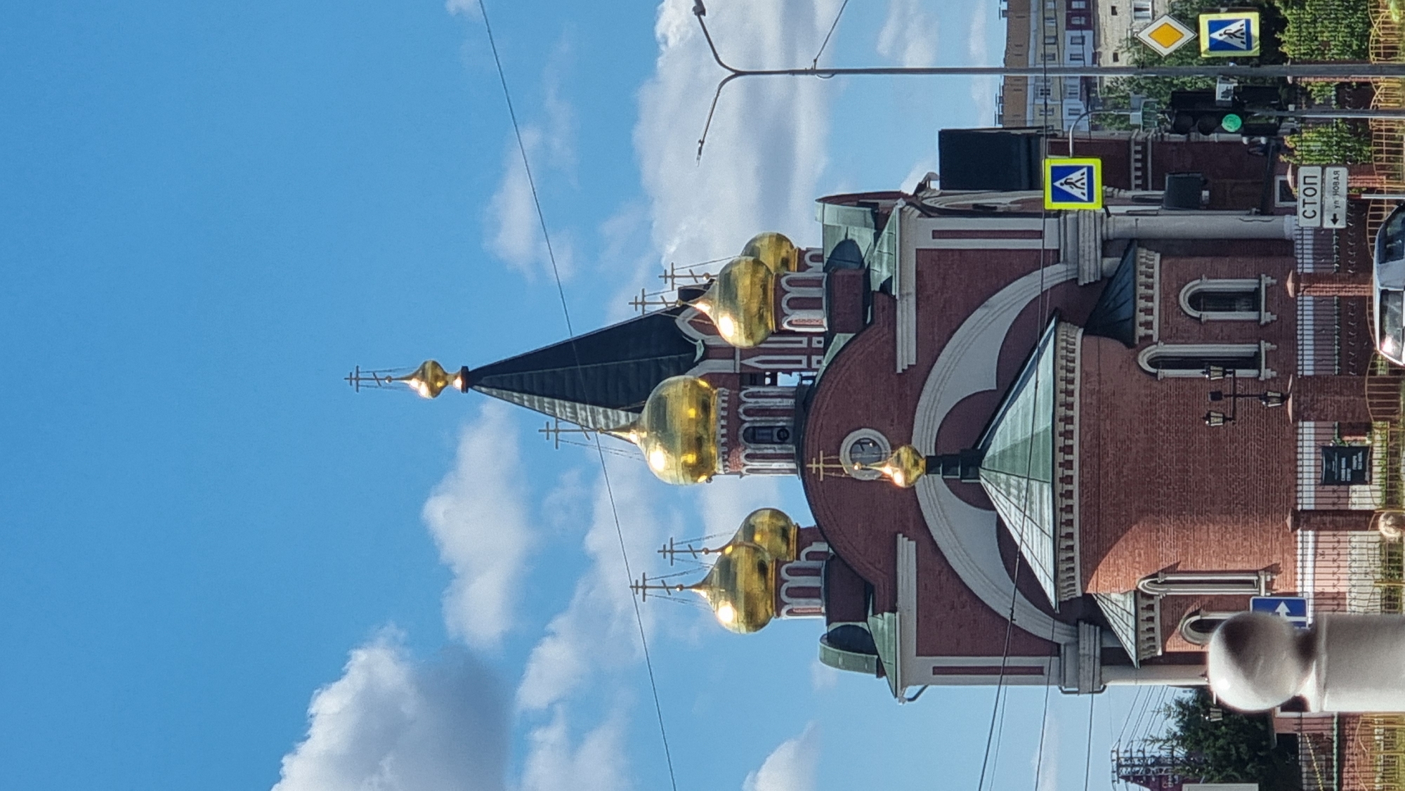 Summer morning streets in Megion, Orthodox domes and petunias