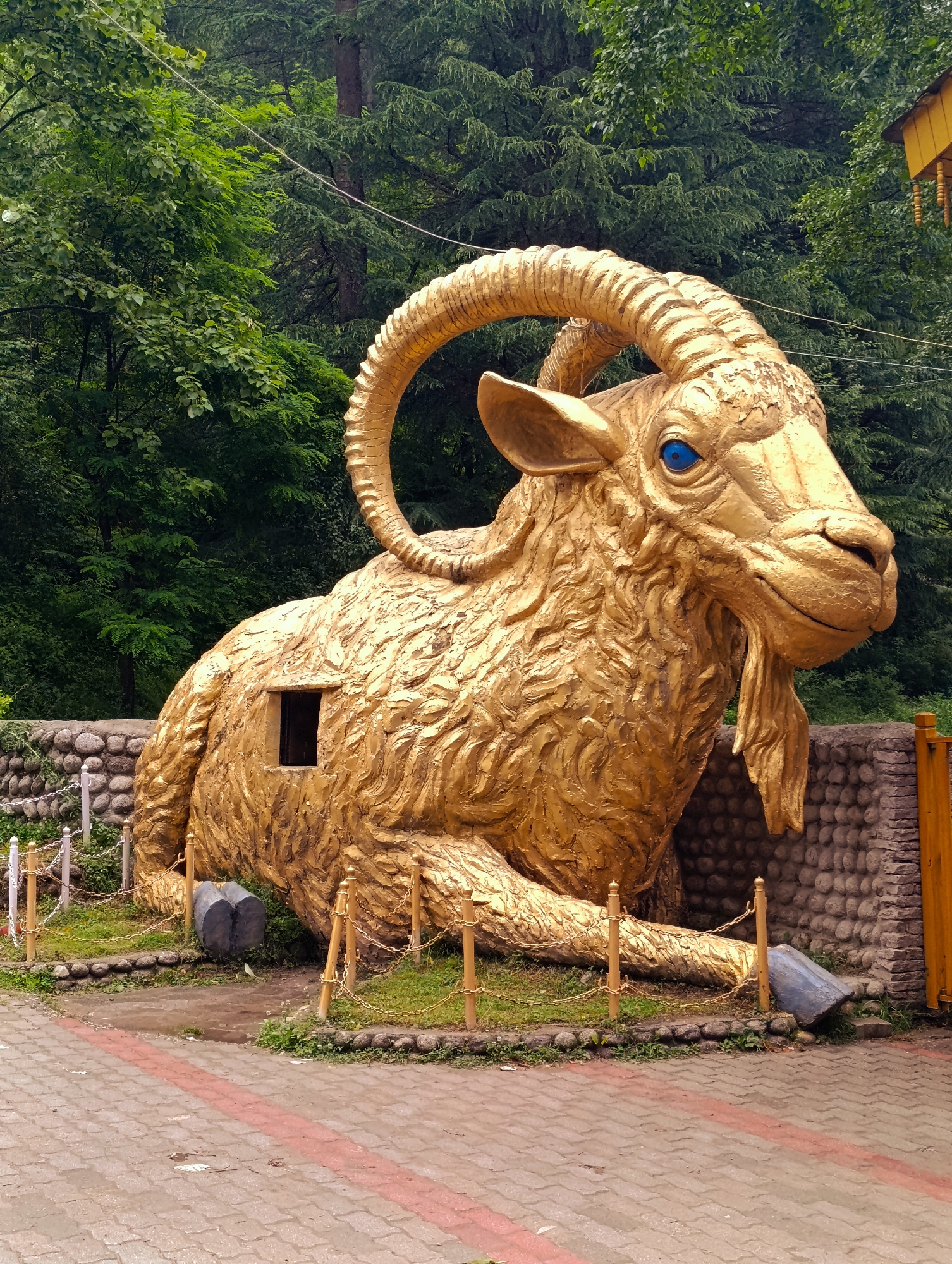 Golden goat statue spotted in Manali amid mountain scenery