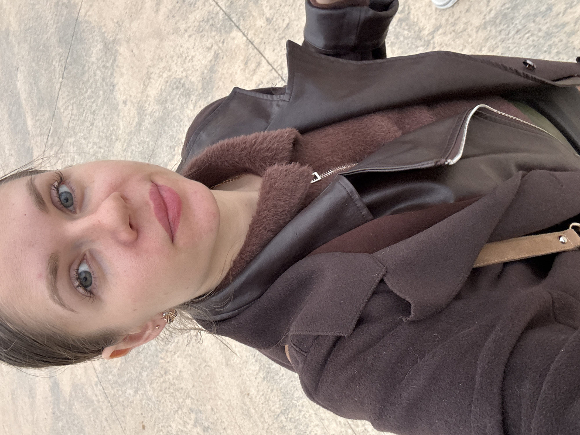 Woman takes selfie near modern buildings in Batumi