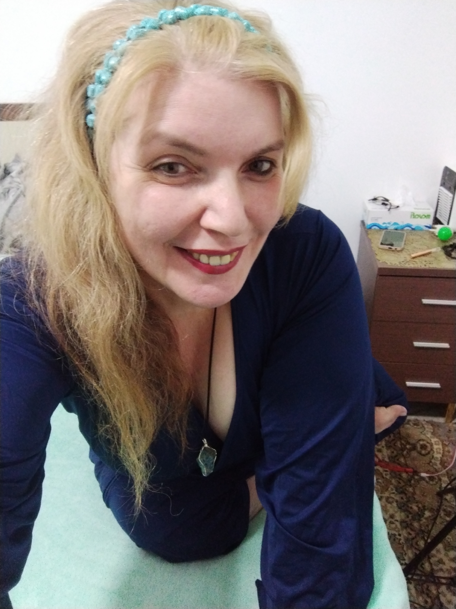 Woman in turquoise headband, maintenance worker documented in UAE
