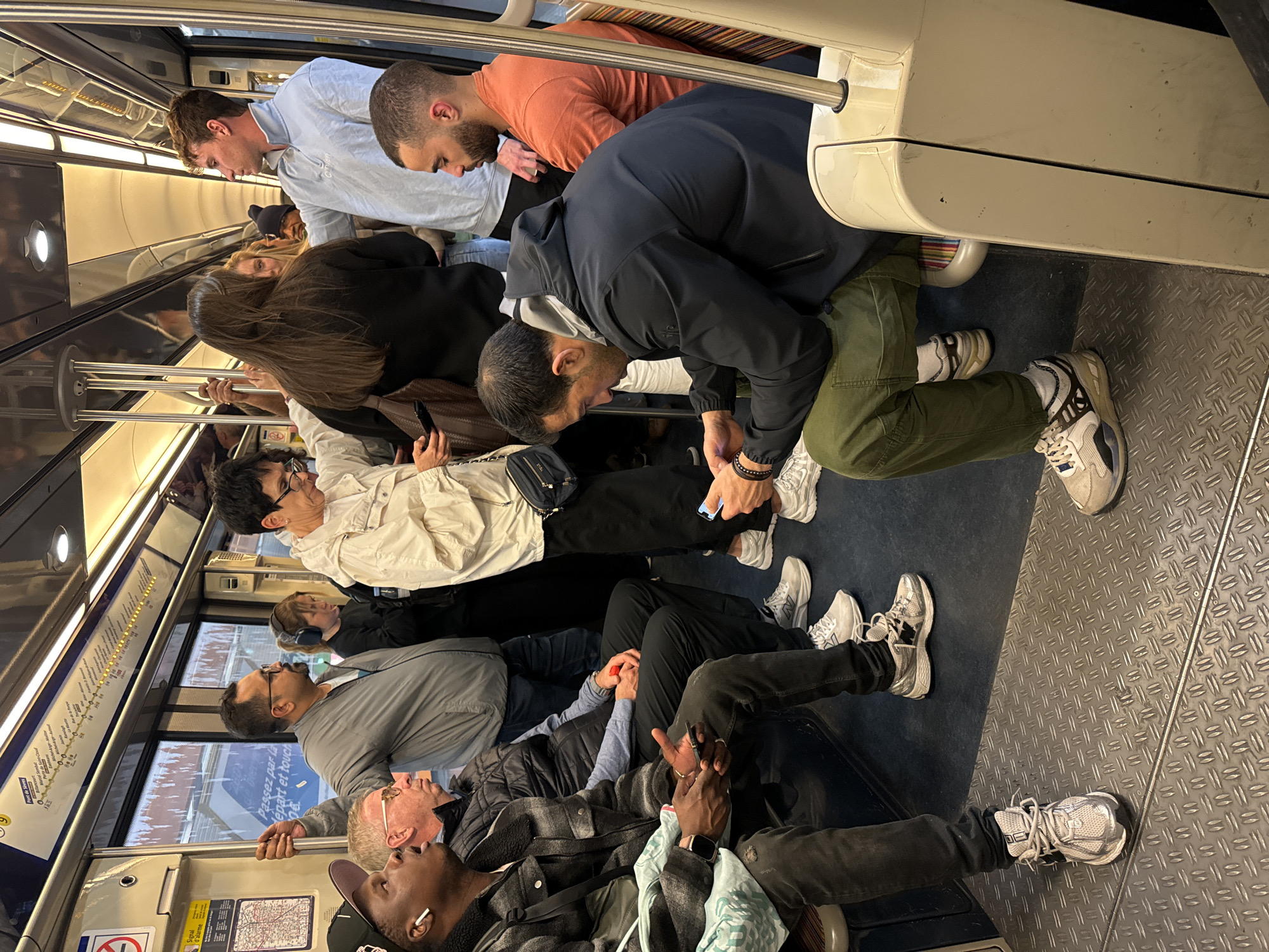 Evening commuters fill Paris subway car during regular transit