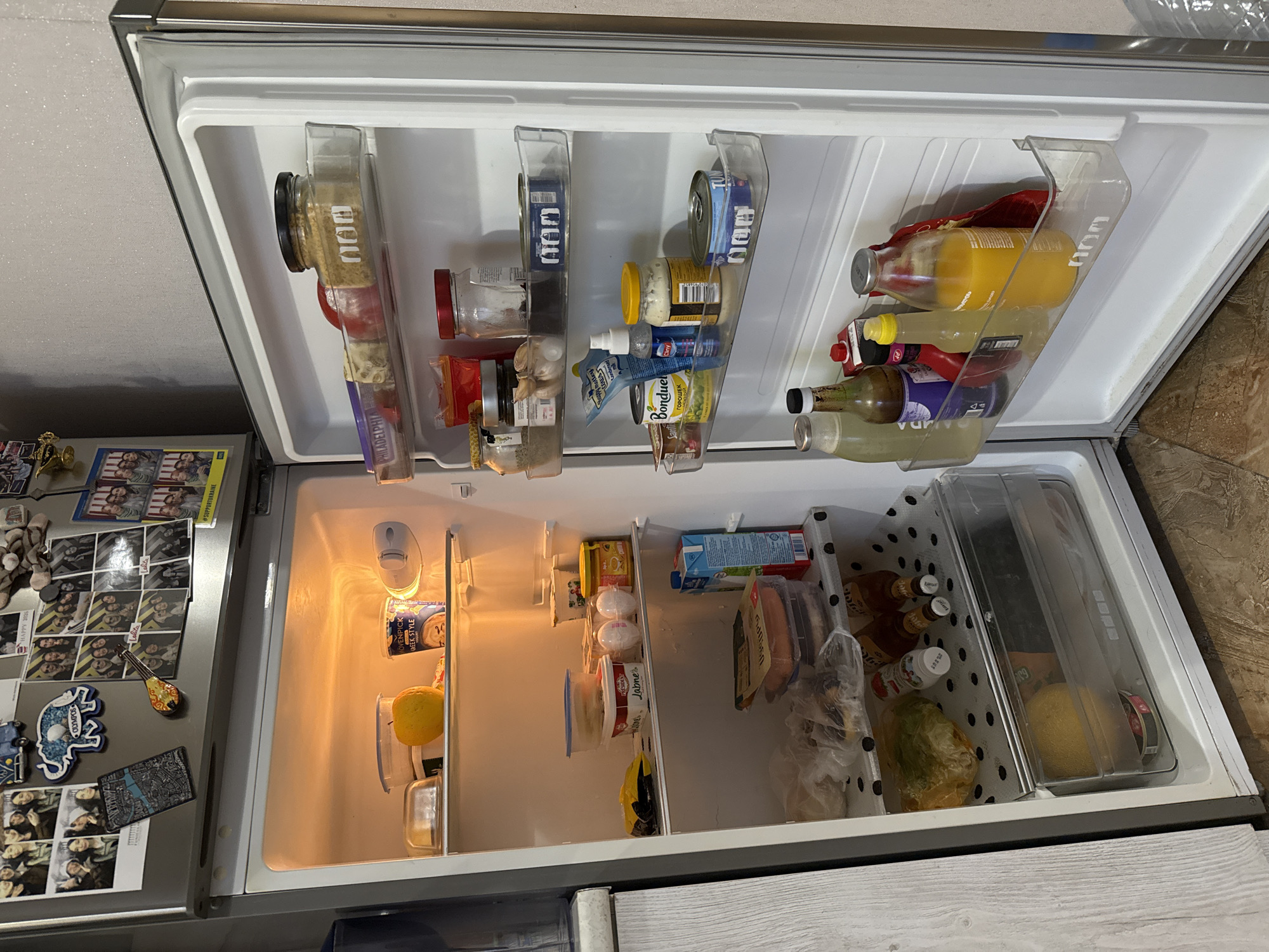 Open refrigerator interior, warm light, Tbilisi