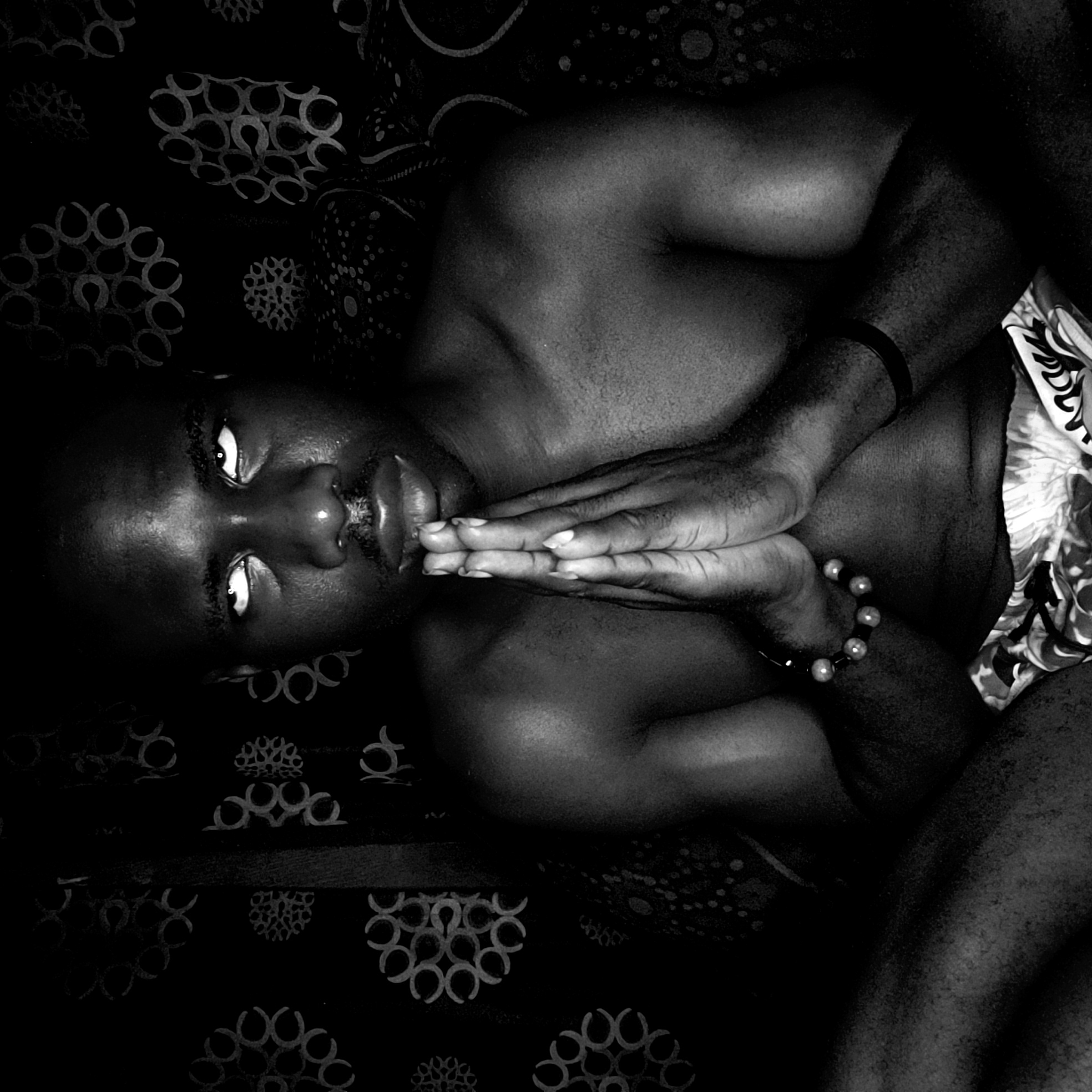Person resting on patterned bedding captured in Narayi, Nigeria