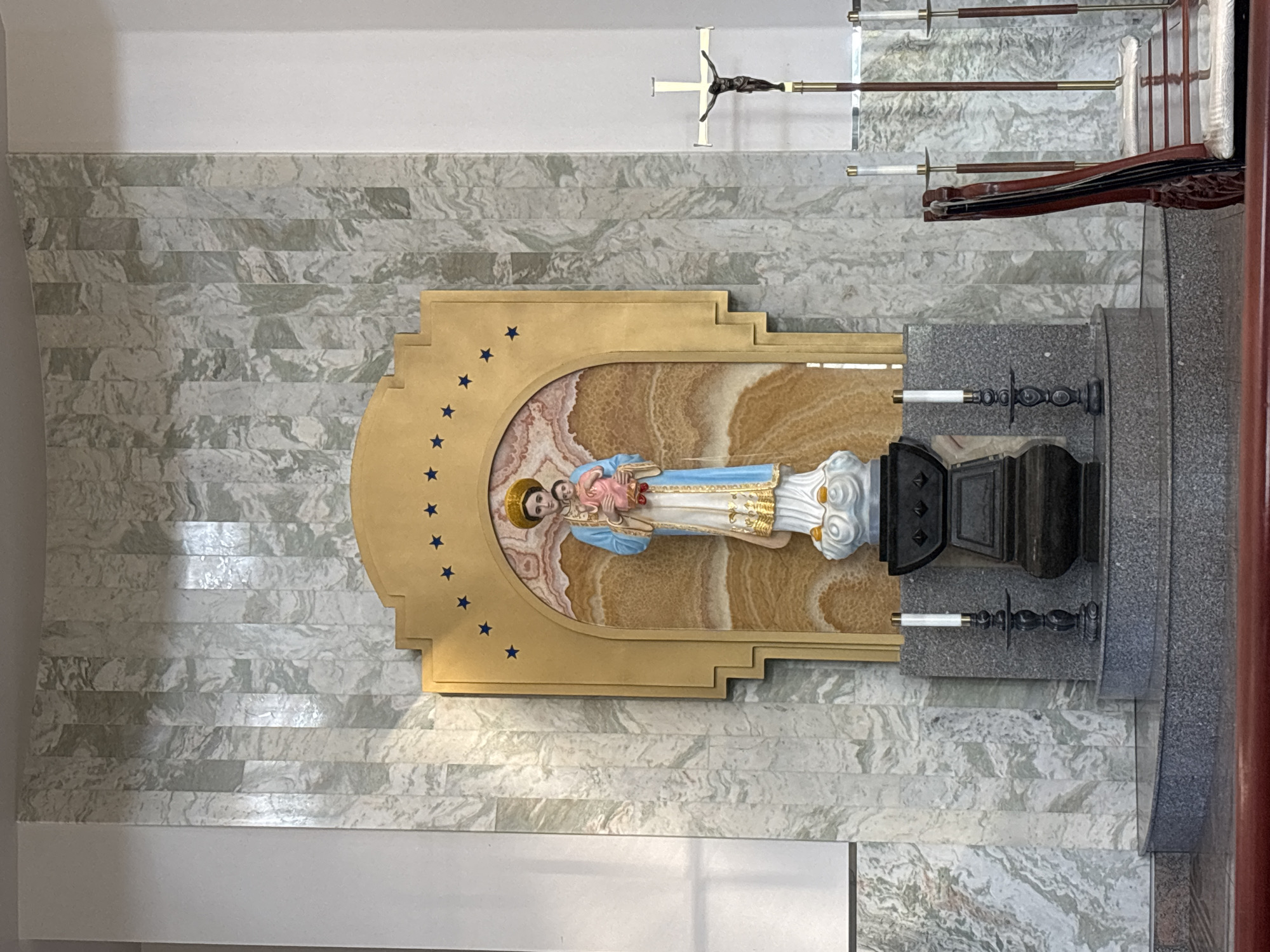 Church interior details in Phoenix: altar statue and wooden crucifix