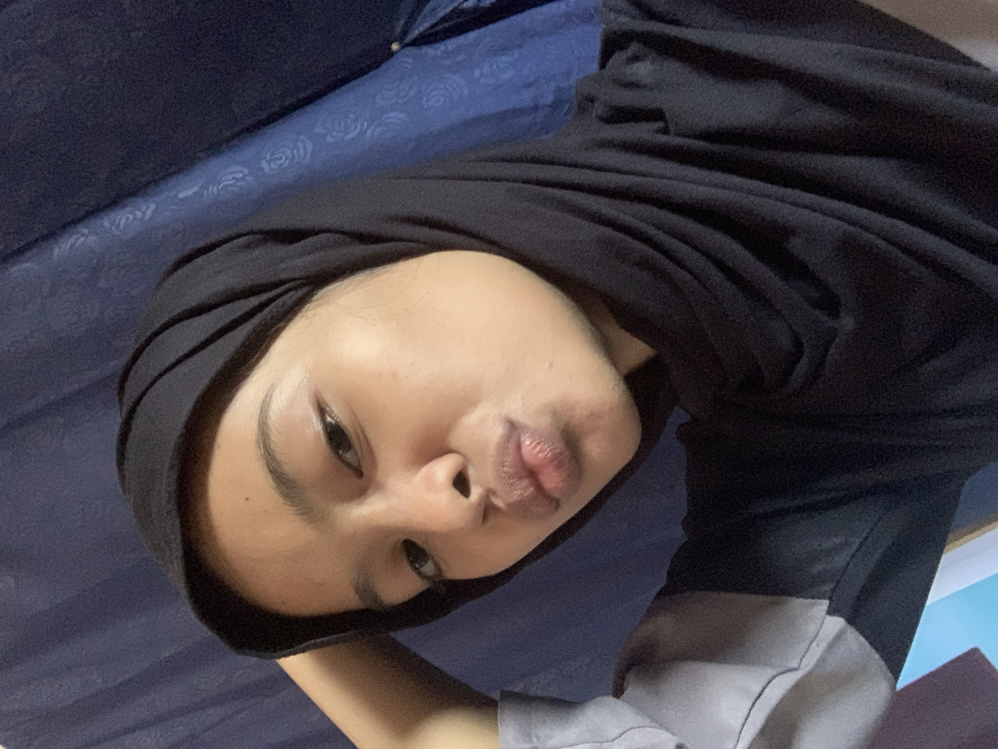Playful selfie session in front of a blue curtain, Sungai Meriam