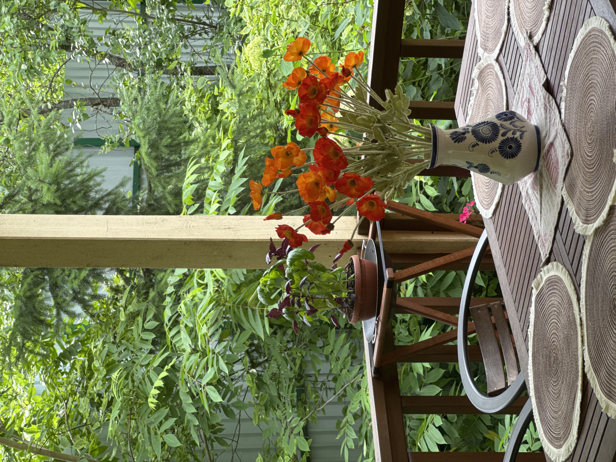 Outdoor table set for a meal on a wooden dacha porch