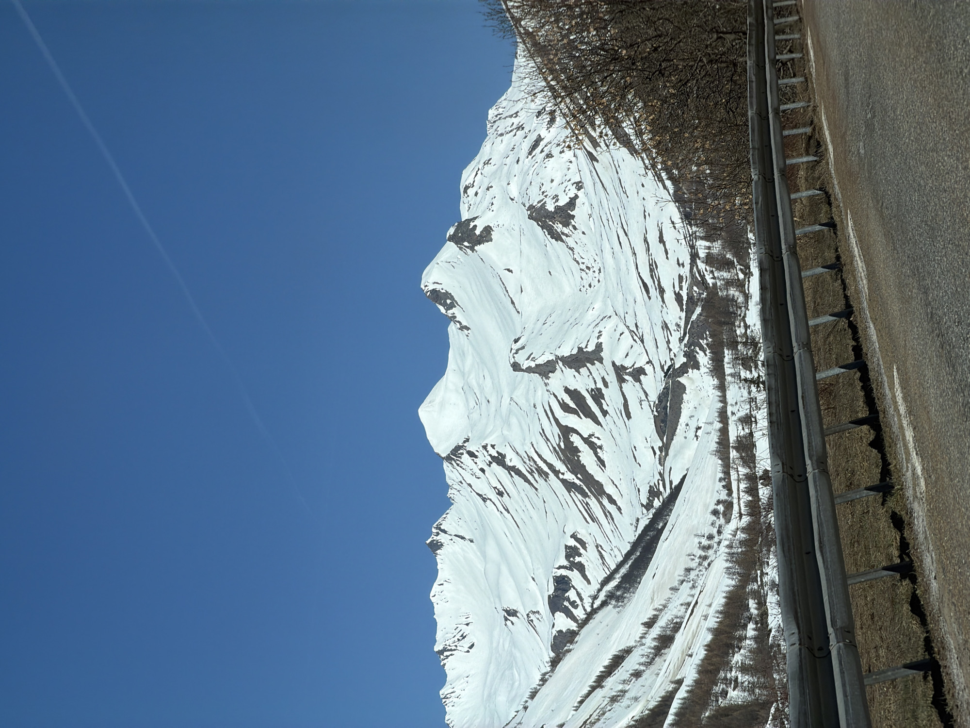Snow-covered mountain face observed from roadside in French Alps