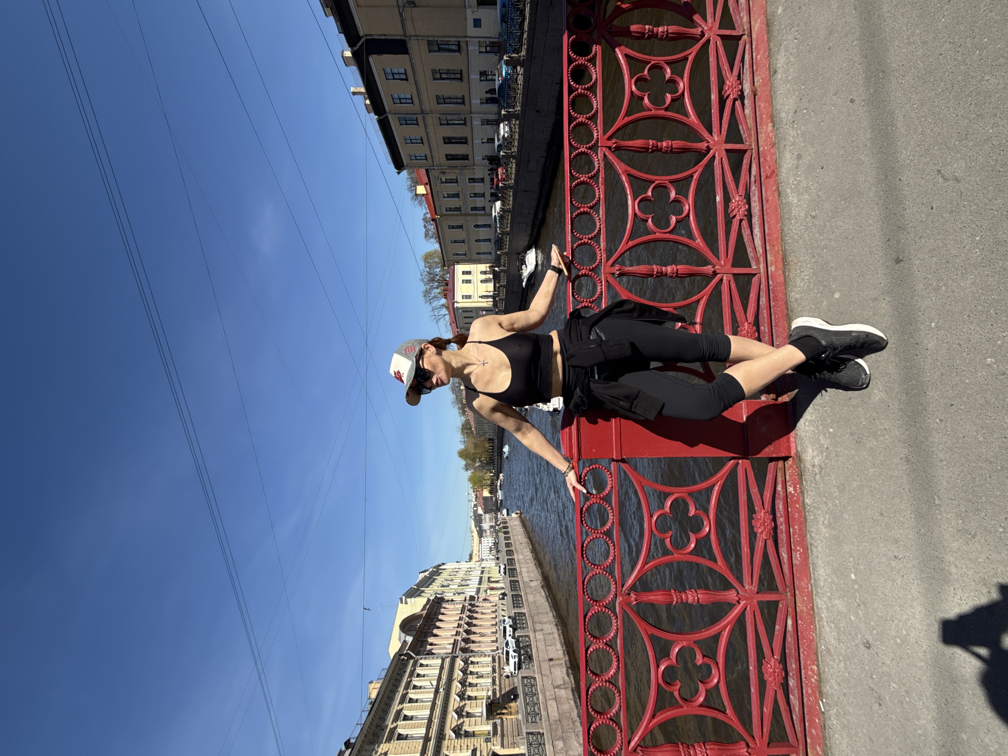 Woman photographed on red bridge in Saint Petersburg