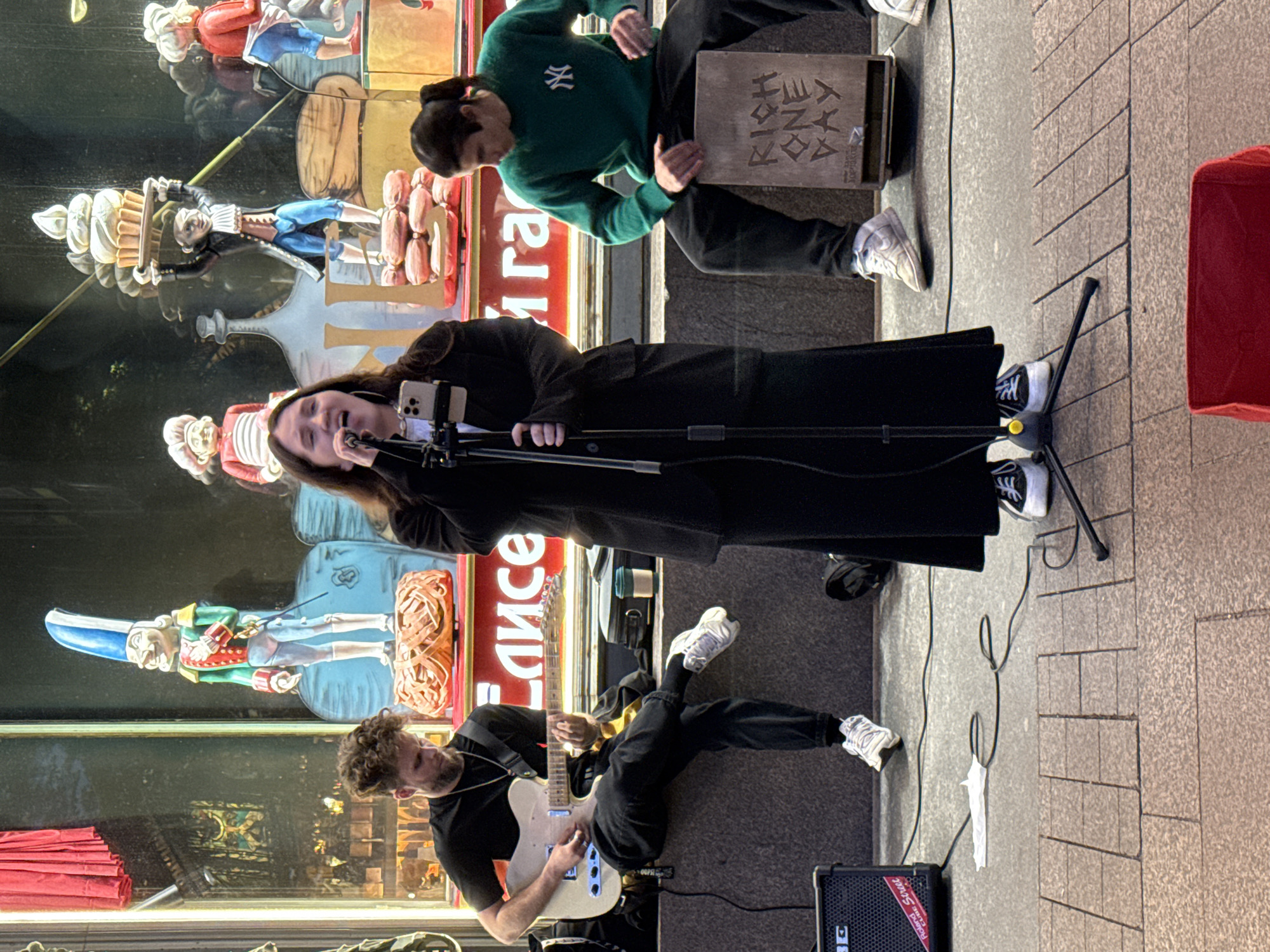 Live street band draws a crowd outside a Saint Petersburg storefront
