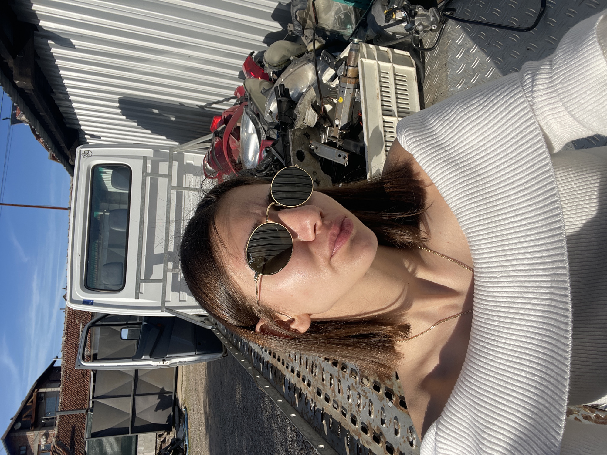 Woman photographed at Sofia junkyard amid damaged vehicles