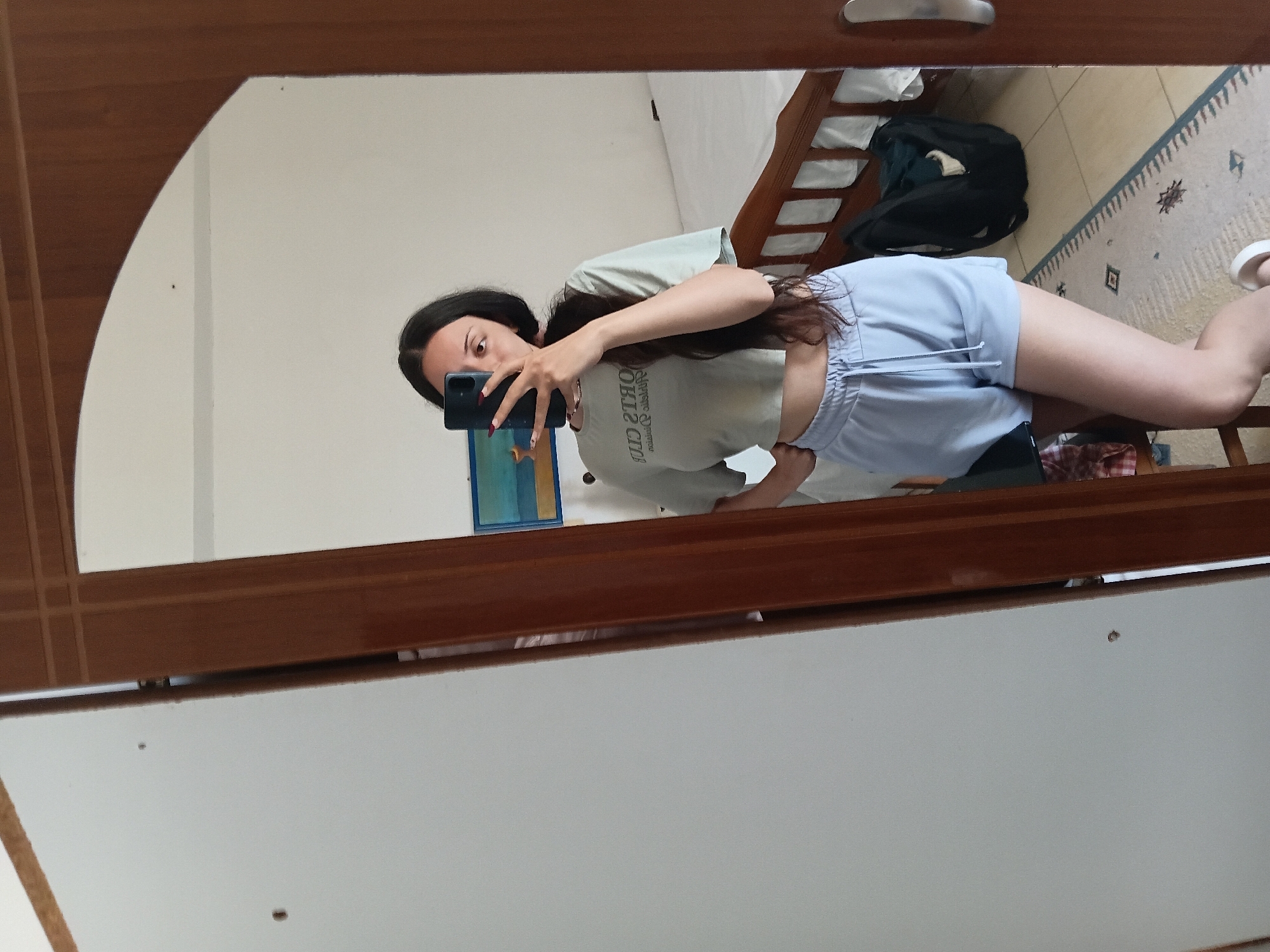 Woman takes morning selfies in bedroom mirror, Vlora Albania