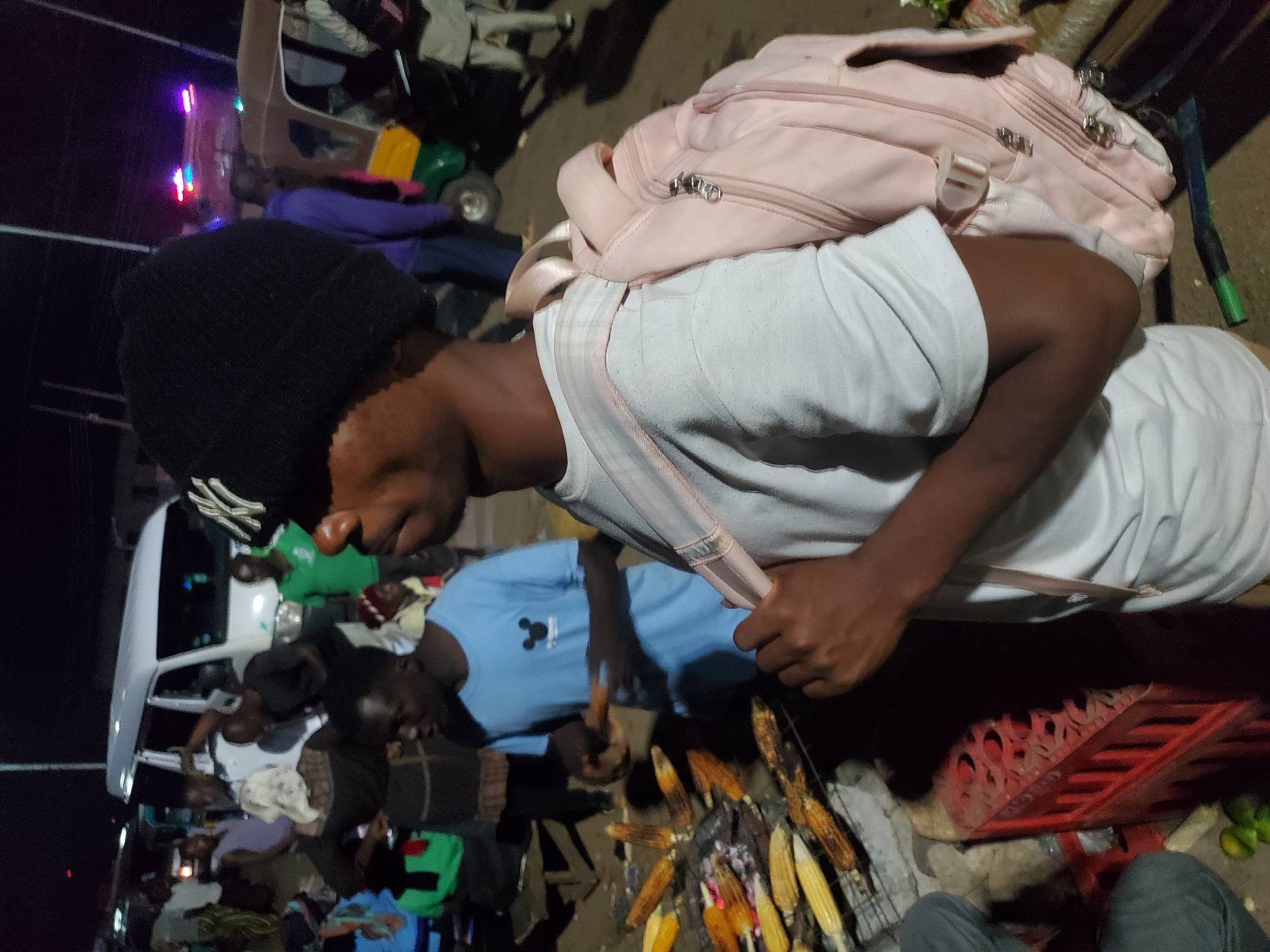 Evening street market bustles with vendors and rickshaws in Bukuru