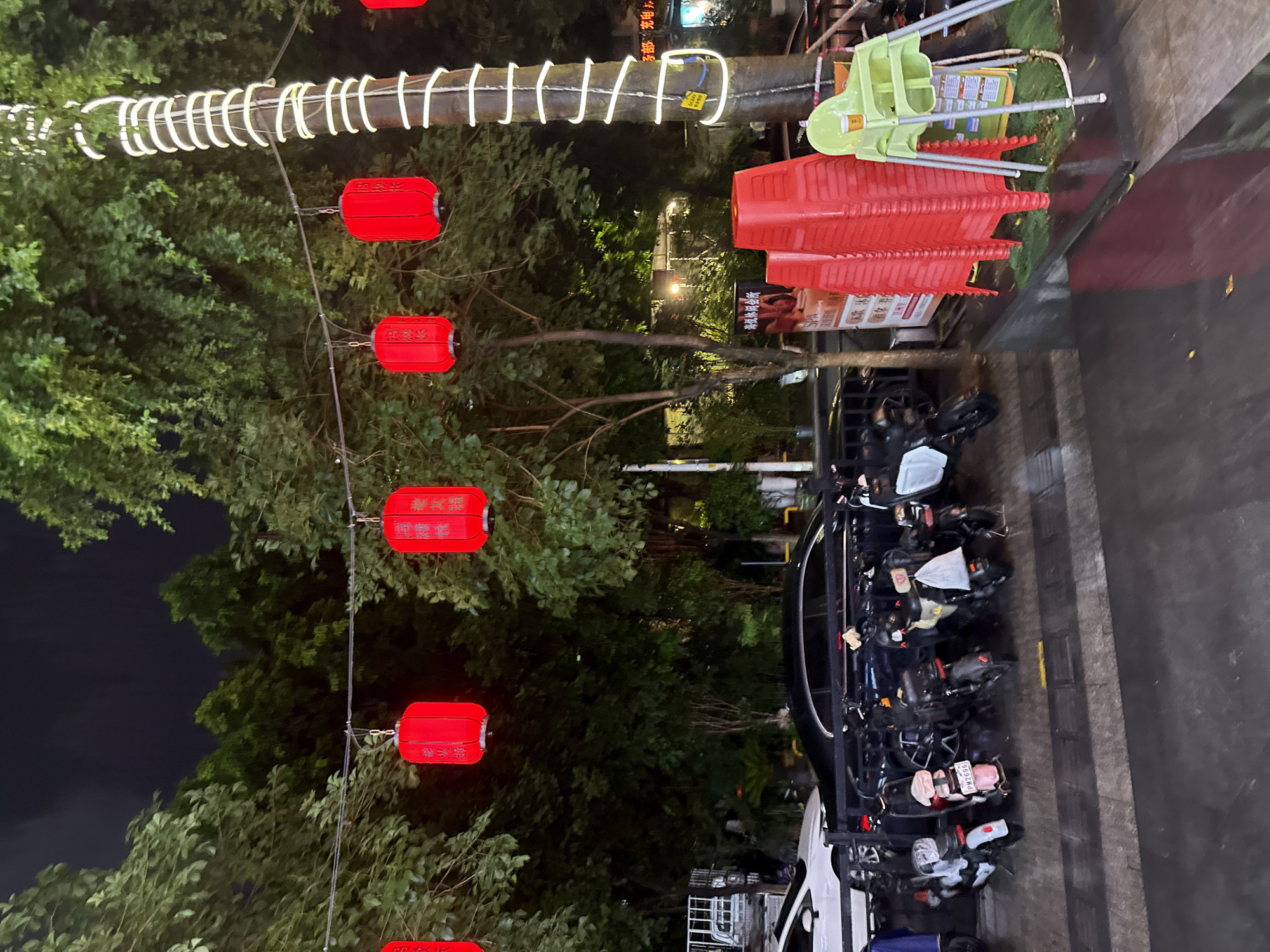 Wet streets and colorful light displays in nighttime Haizhu District