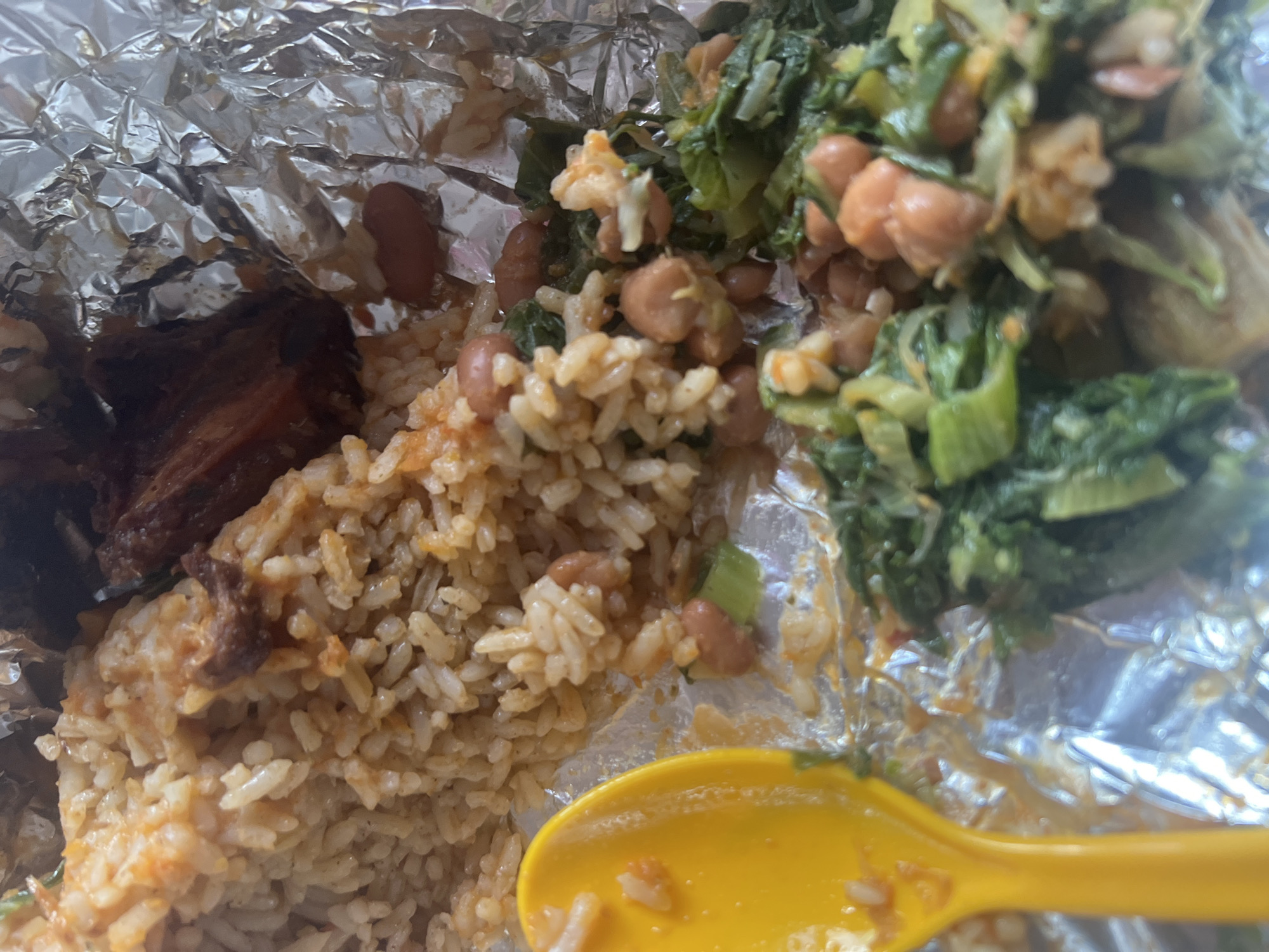 Takeout meal documented in aluminum container in Dar es-Salaam
