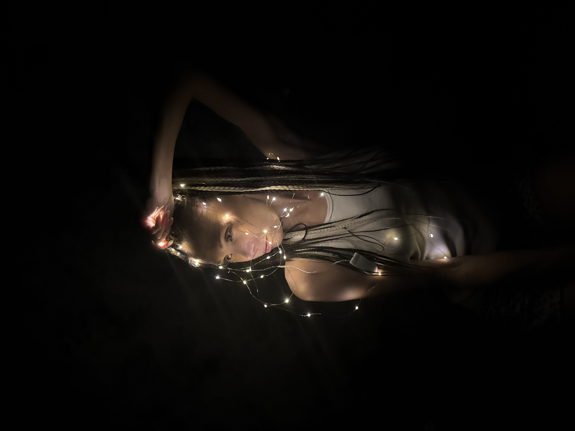Person rests among fairy lights in Zhukovo, Russia