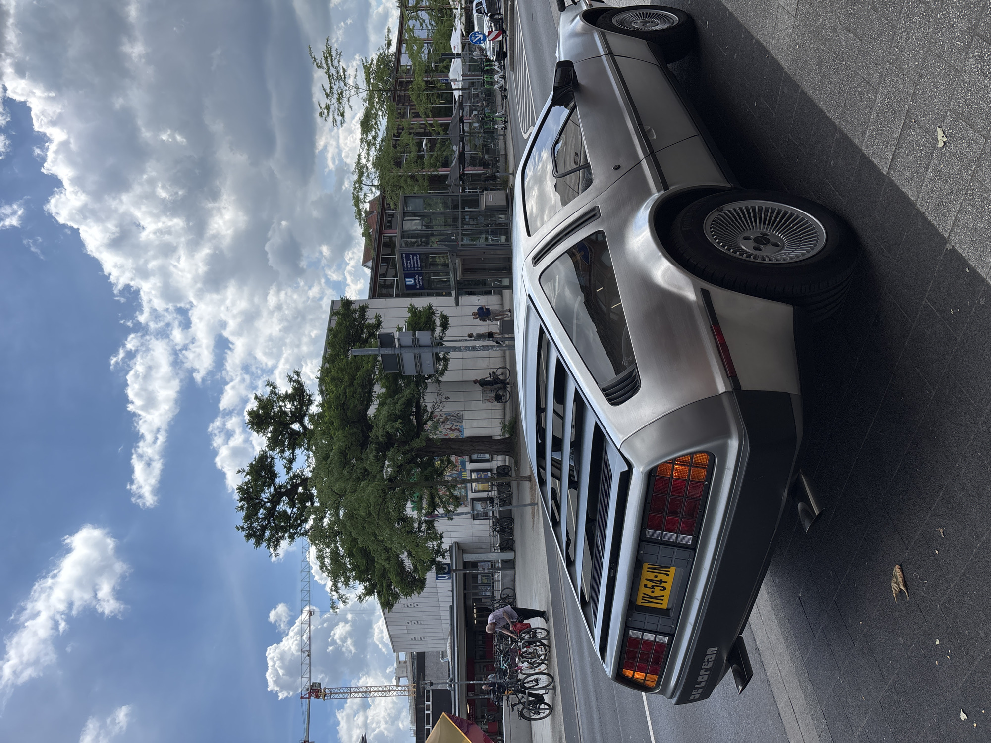 DeLorean parked in sunny Hanover, near cafe and fountain