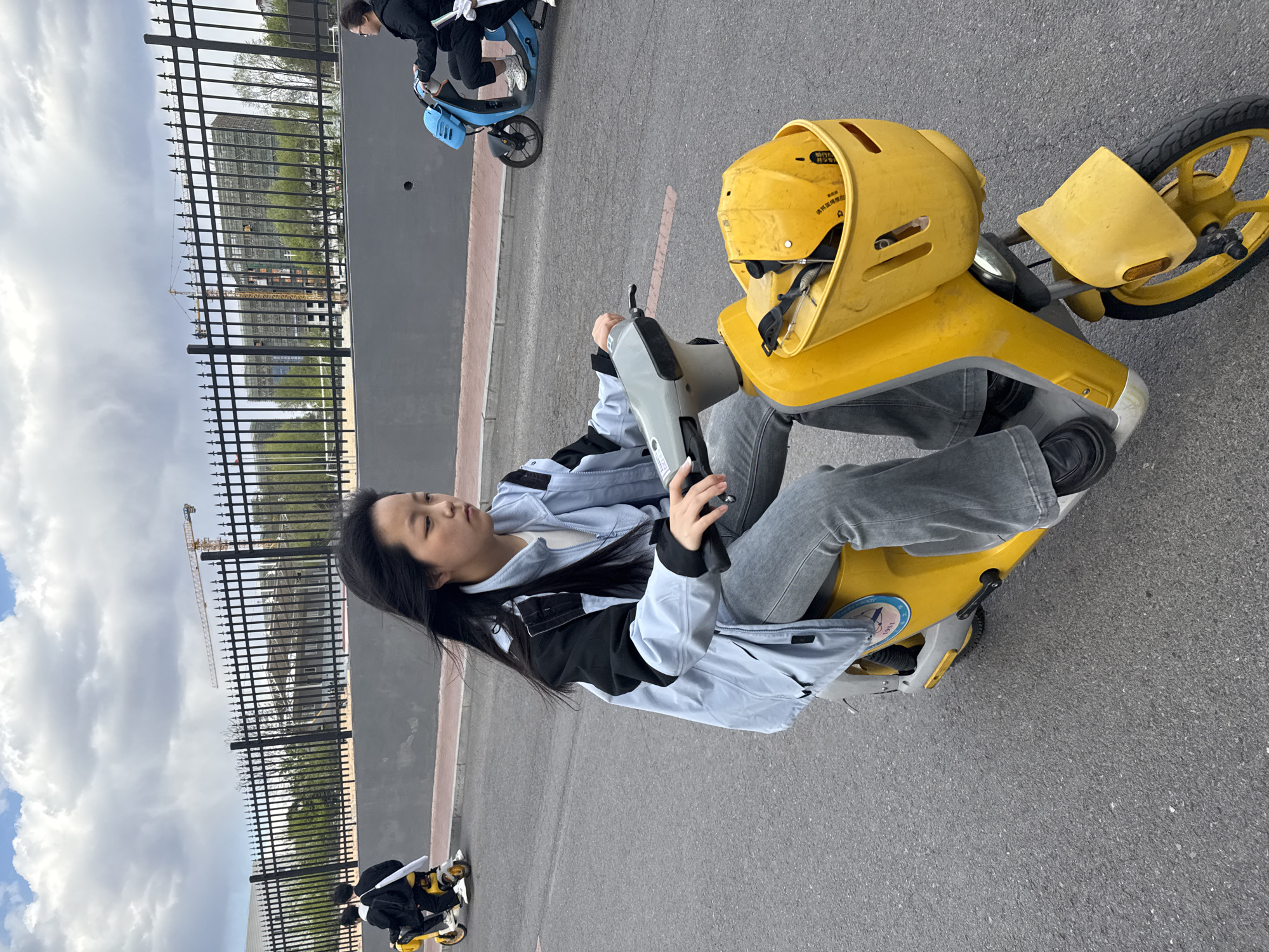 Women spotted on scooters, sidewalks in Zhongtun morning scenes