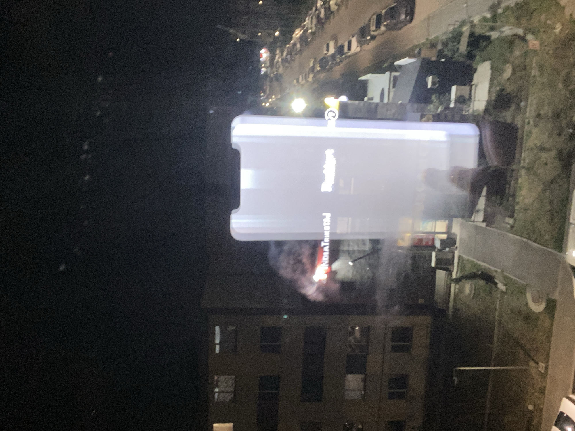Oversized smartphone-shaped ad lights up a city night