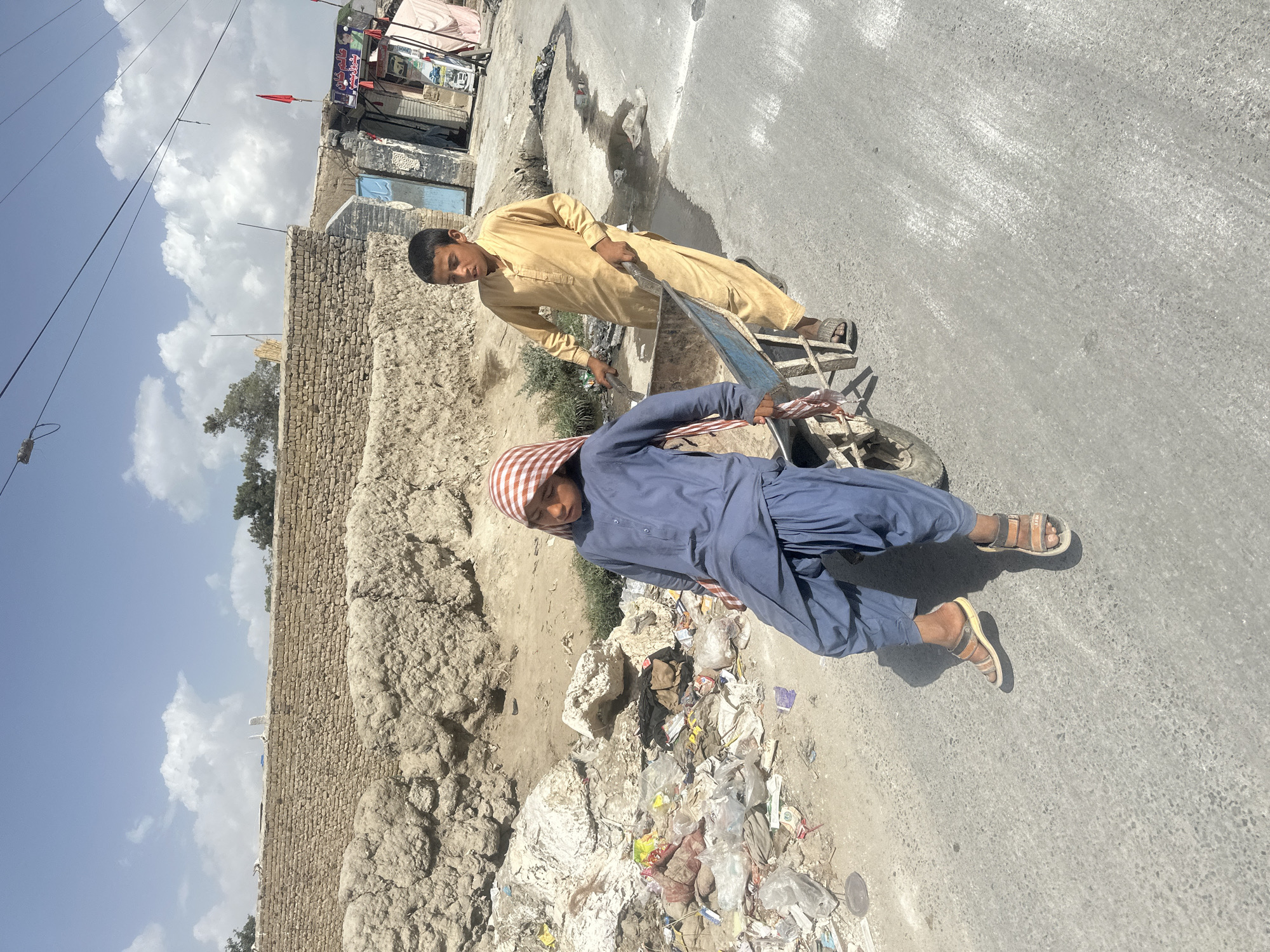 Wheelbarrow ride on a dirt road in Quetta