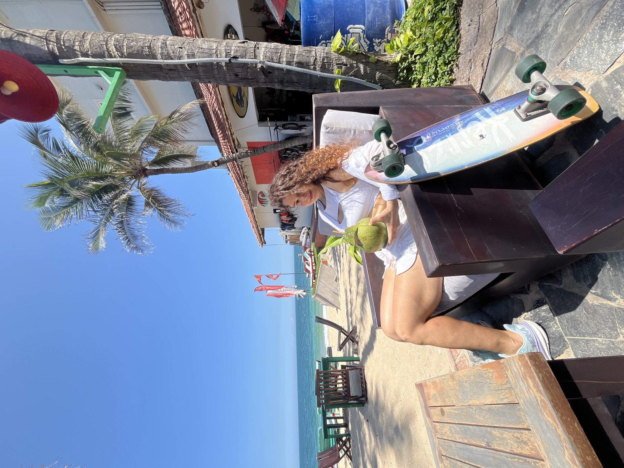 Coconuts and surfboards on a sunny Phan Thiết beach morning