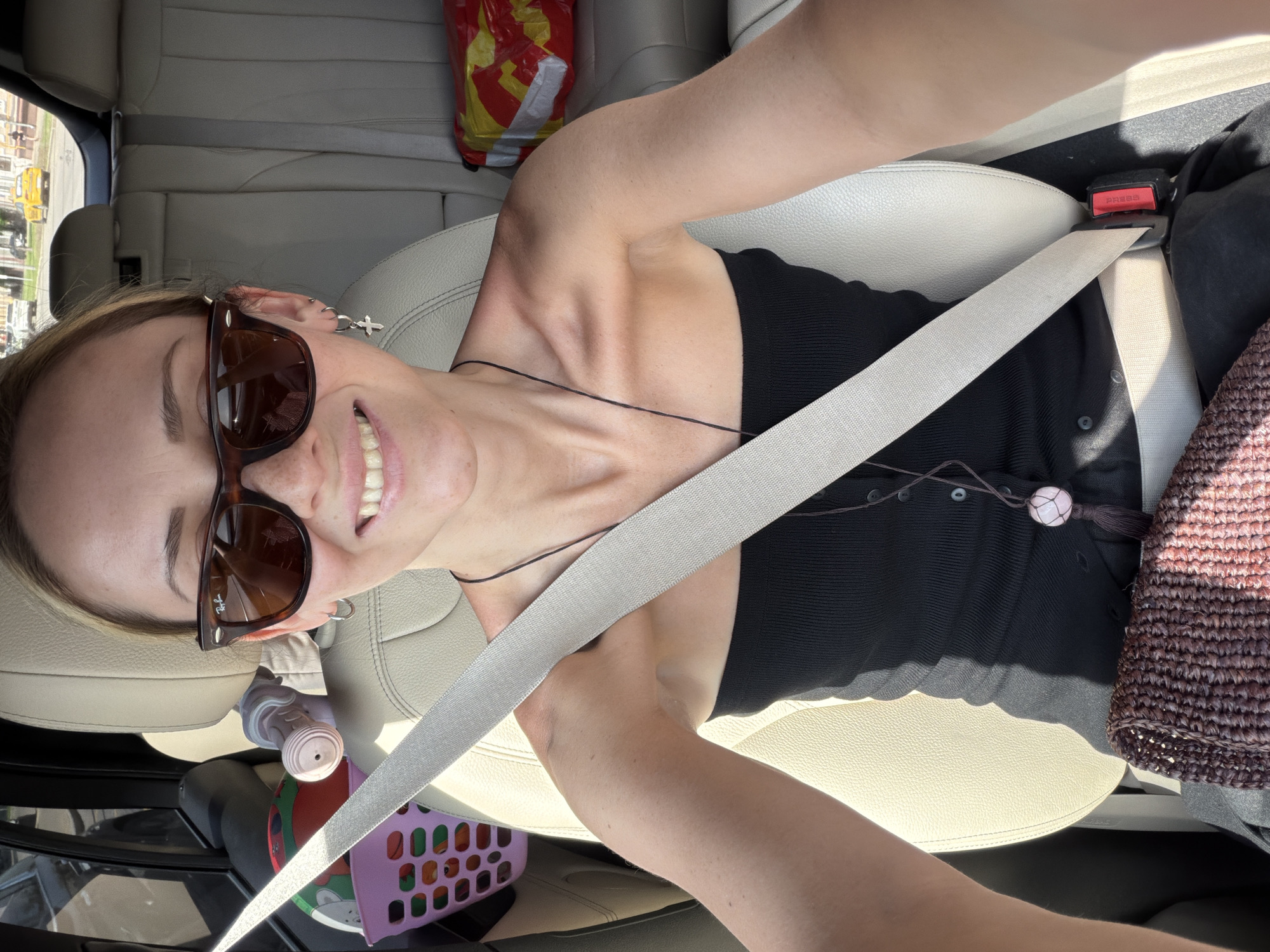 Woman takes selfie from car passenger seat in Moscow