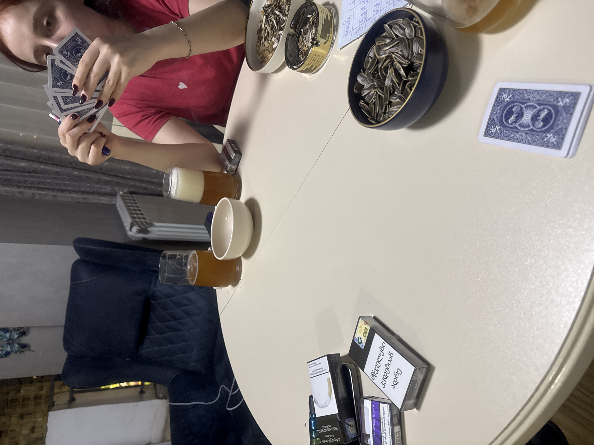Card game and casual gathering documented in Tbilisi home