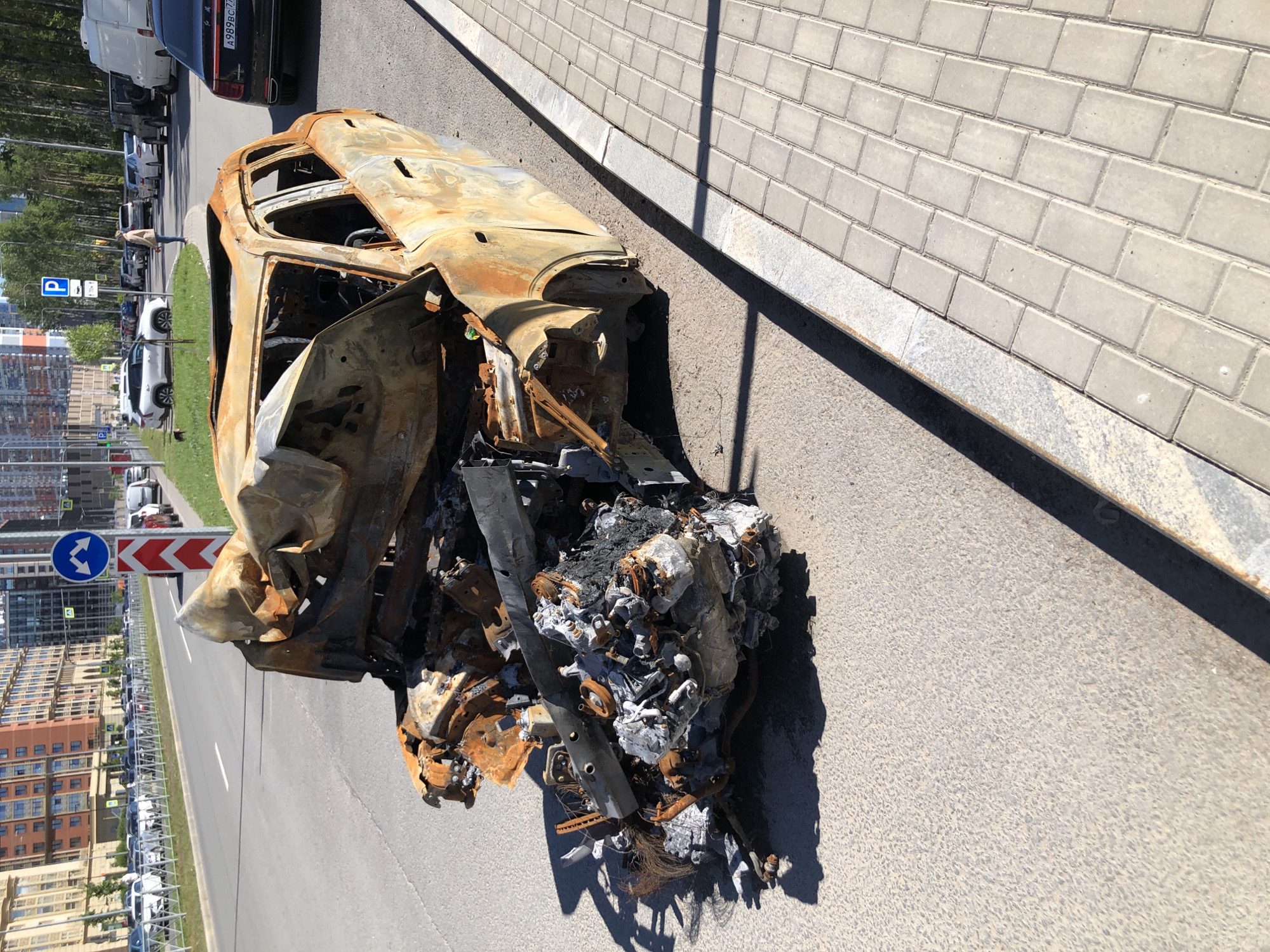 Burnt-out SUV aftermath documented on Saint Petersburg street