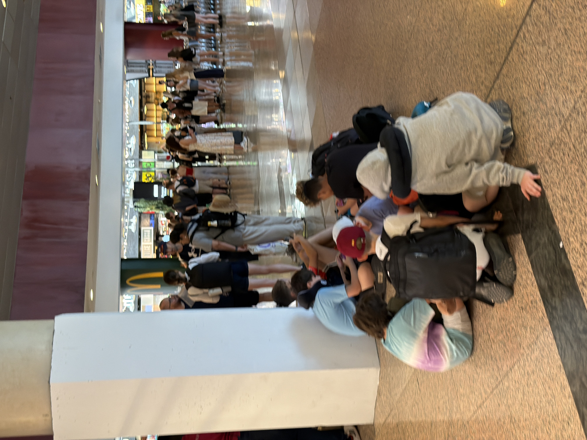Busy afternoon crowd flowing through Barcelona-El Prat Airport terminal