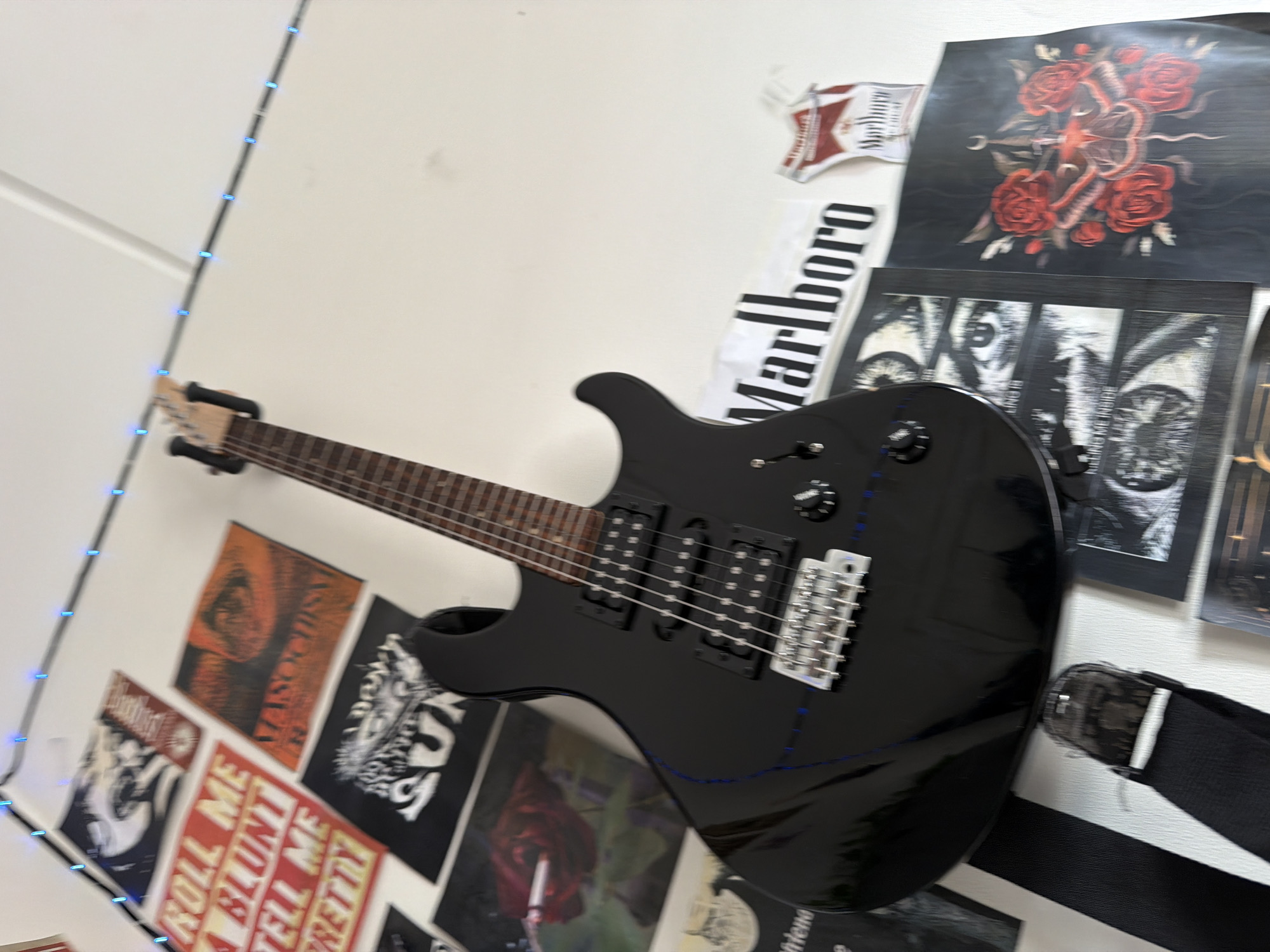 Oslo bedroom wall: guitar, posters, Monster can, late morning vibes