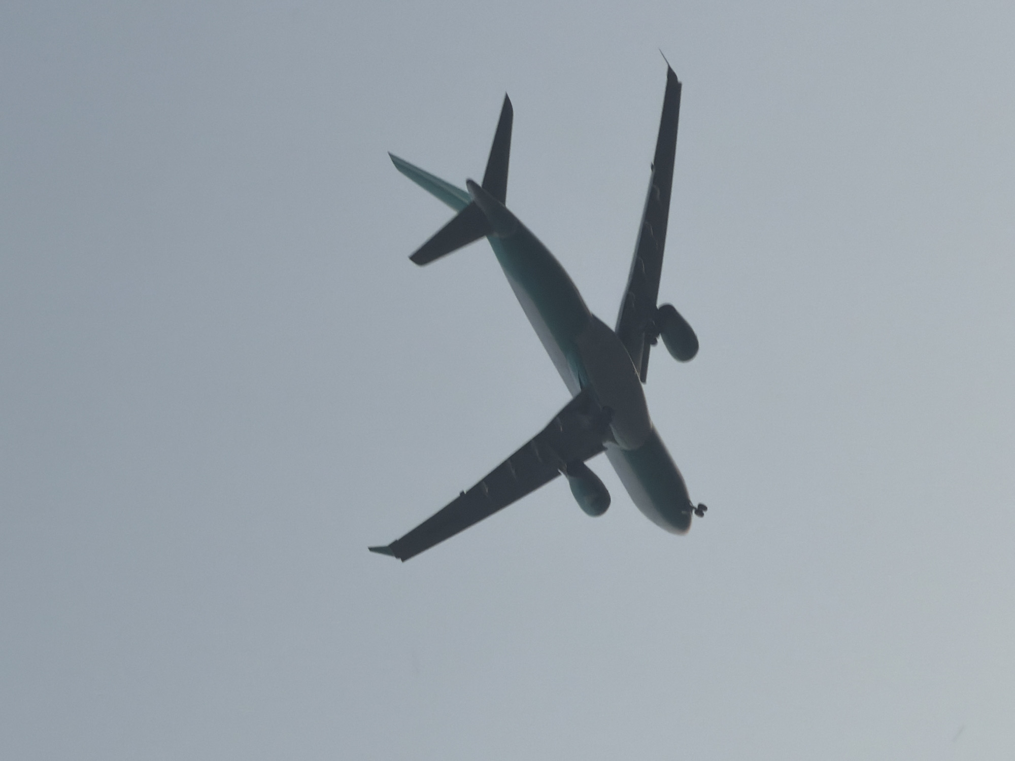 Planes cross a Delhi sunset sky from a rooftop viewpoint
