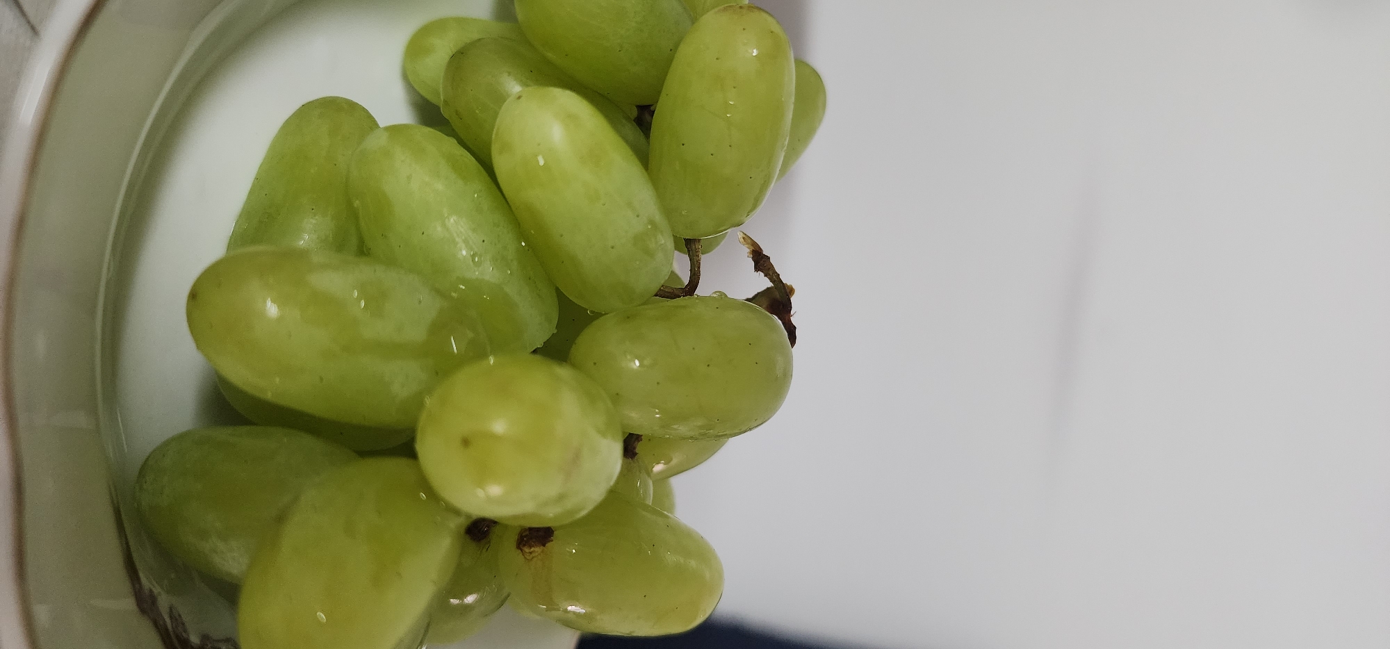 Fresh grapes and a blue flower, close up in Sderot