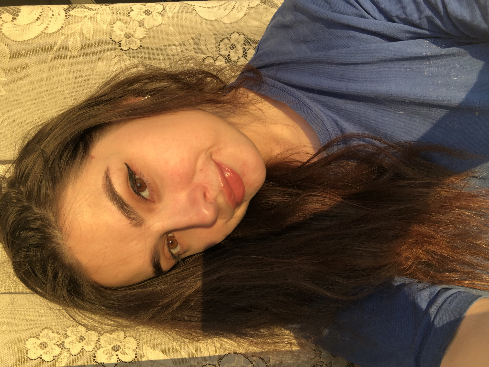 Woman creates content at home, photographing selfies and phone cases