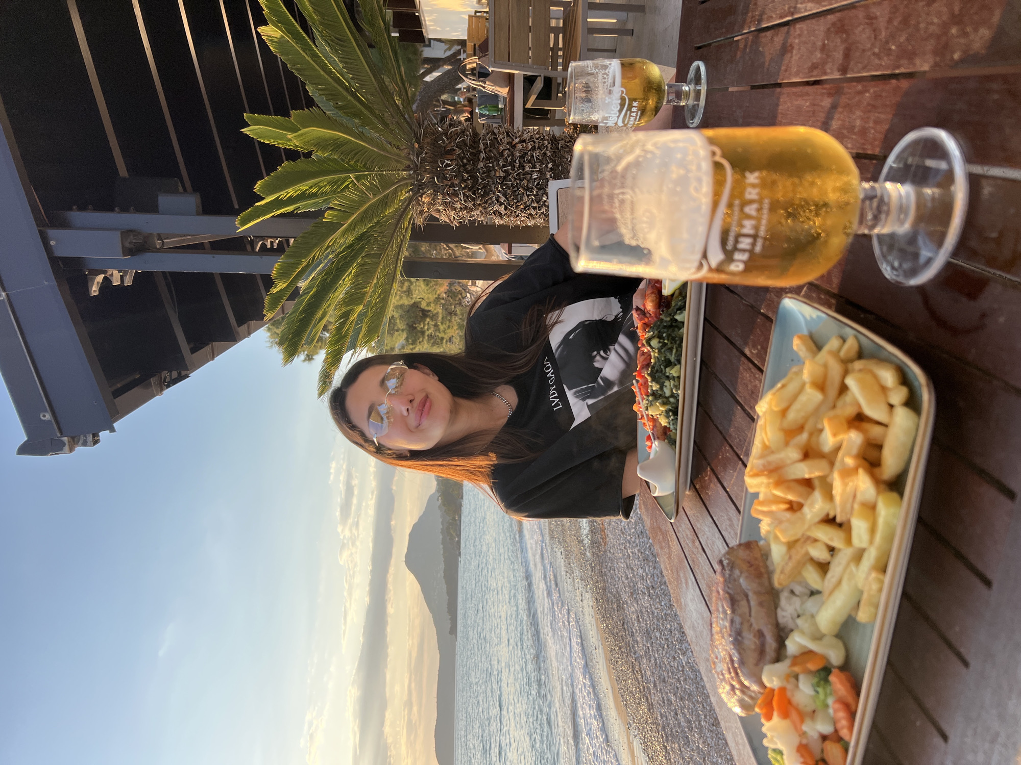 Woman enjoys beachside dining in Bar, Montenegro